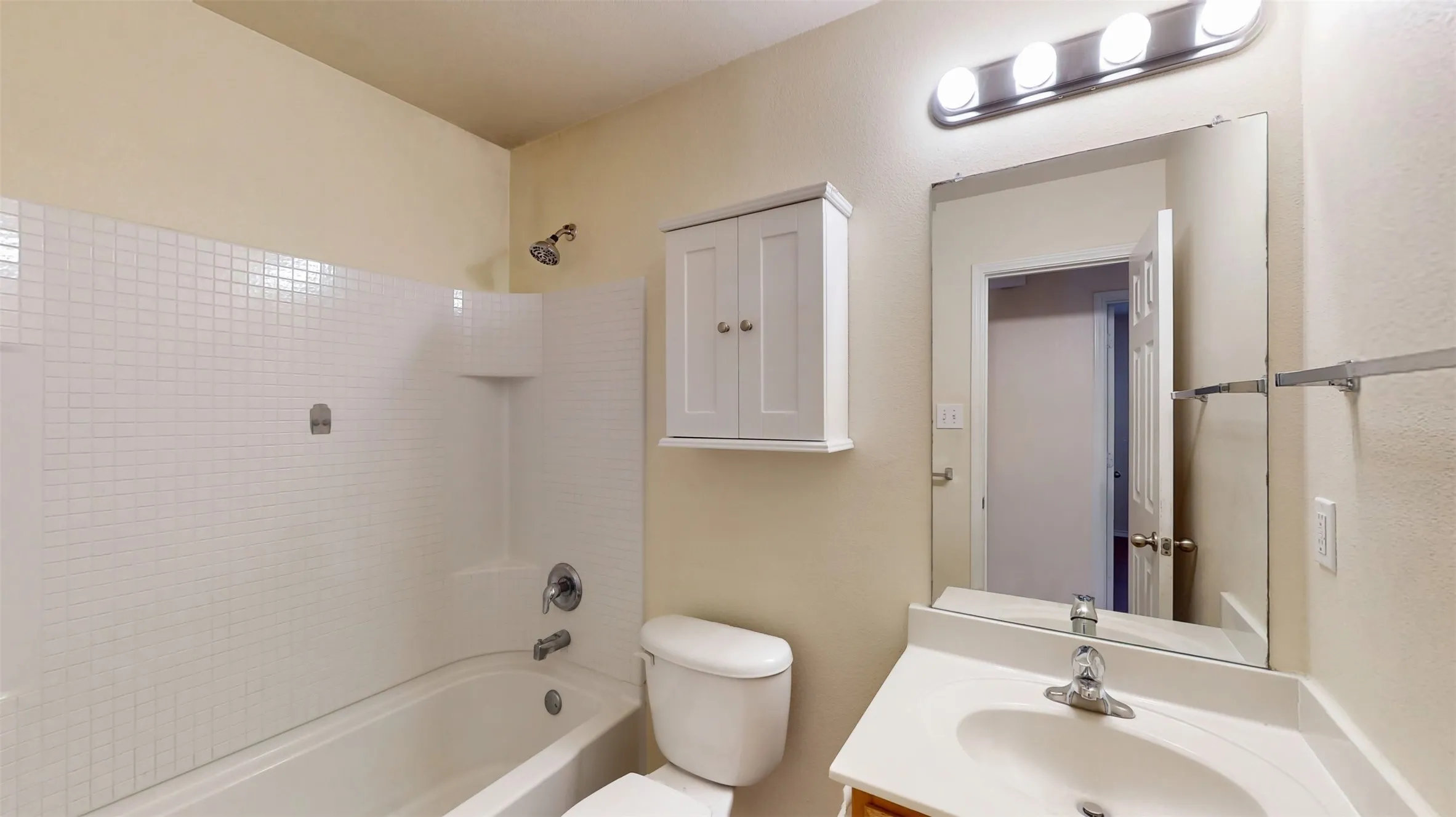 Hall bathroom has a combination tub and shower.