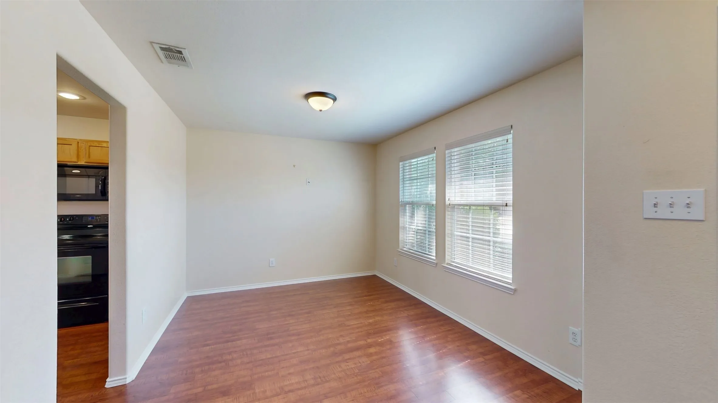 Dining room has a view of the landscaped front yard.