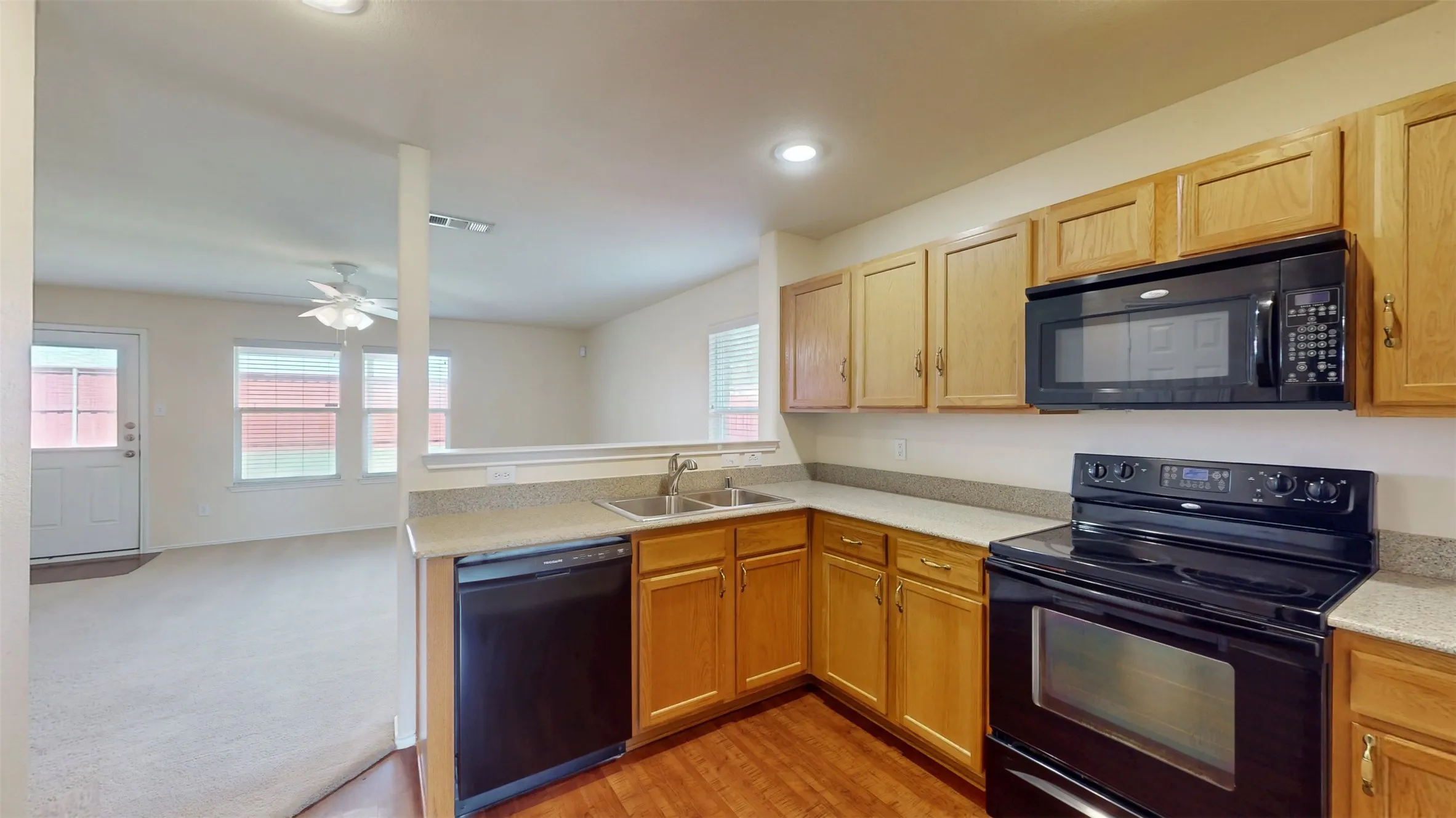 Kitchen features sleek black appliances! Dishwasher, electric range and built-in microwave included!