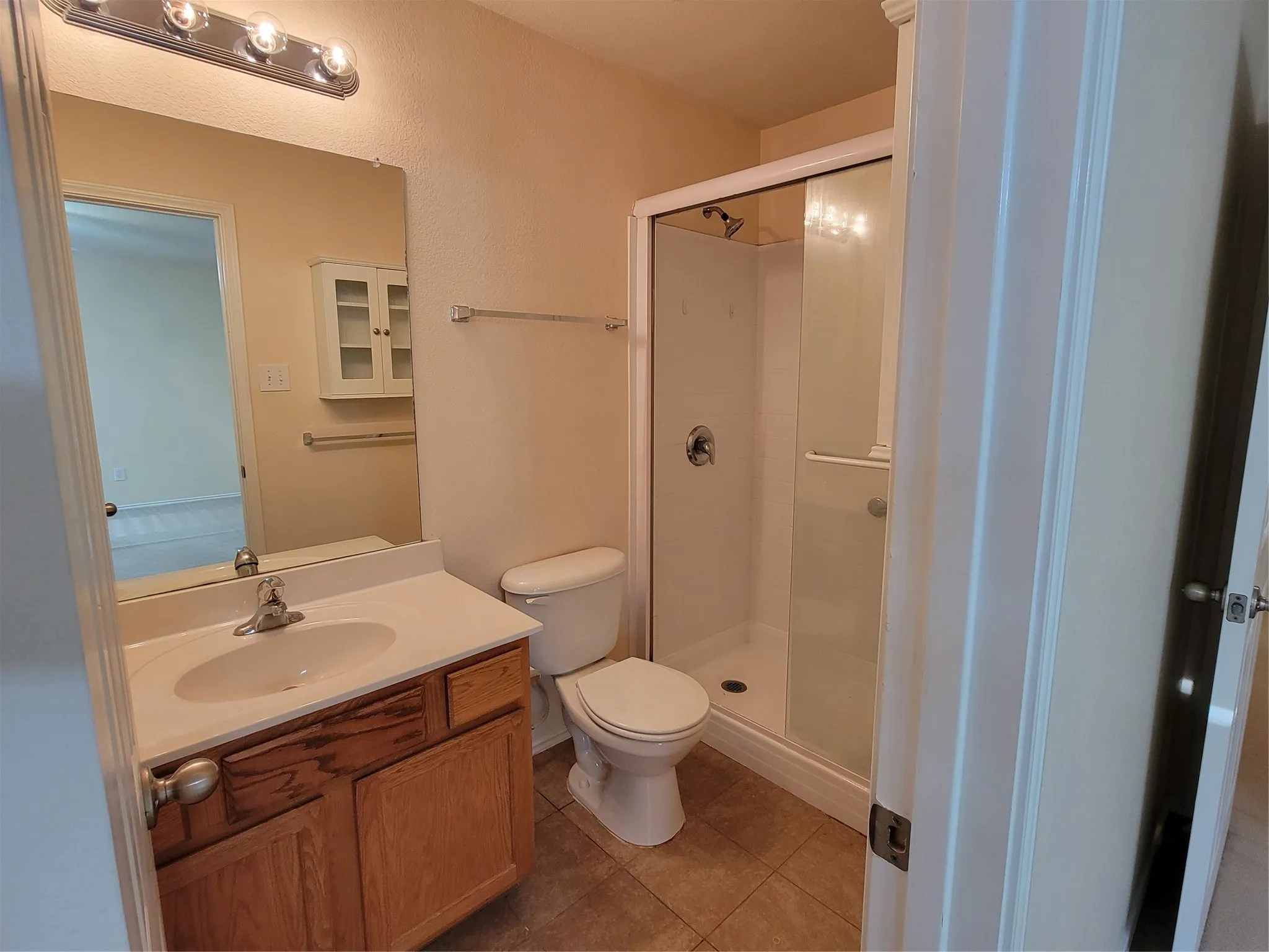 Primary ensuite bathroom has a step-in shower and built-in storage vanity.