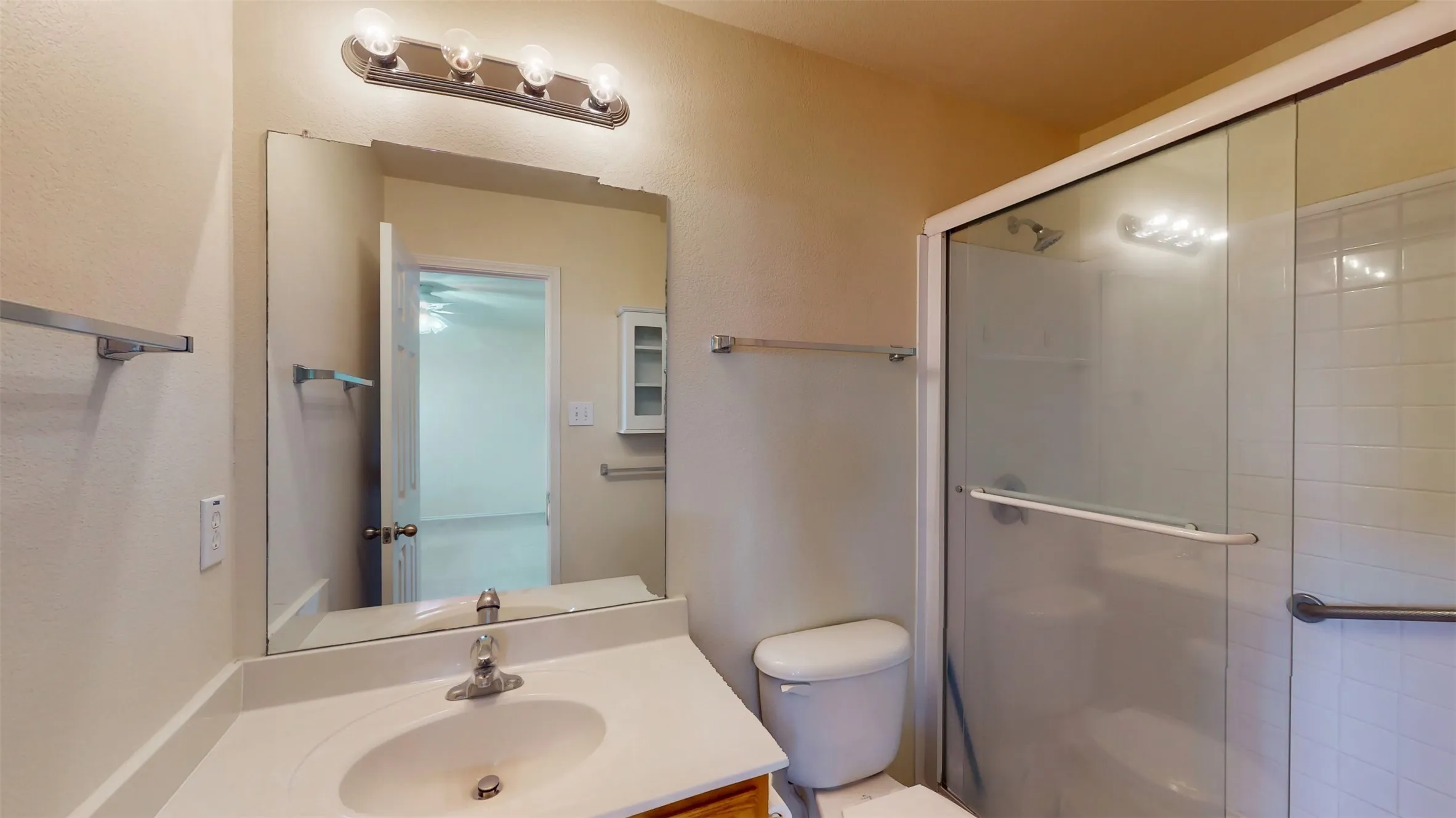 Ample lighting and towel storage in the primary bathroom!