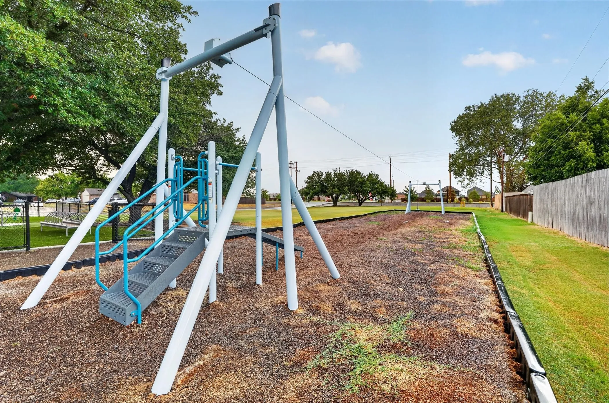 Playground area with a metal structure, steps, and handrails