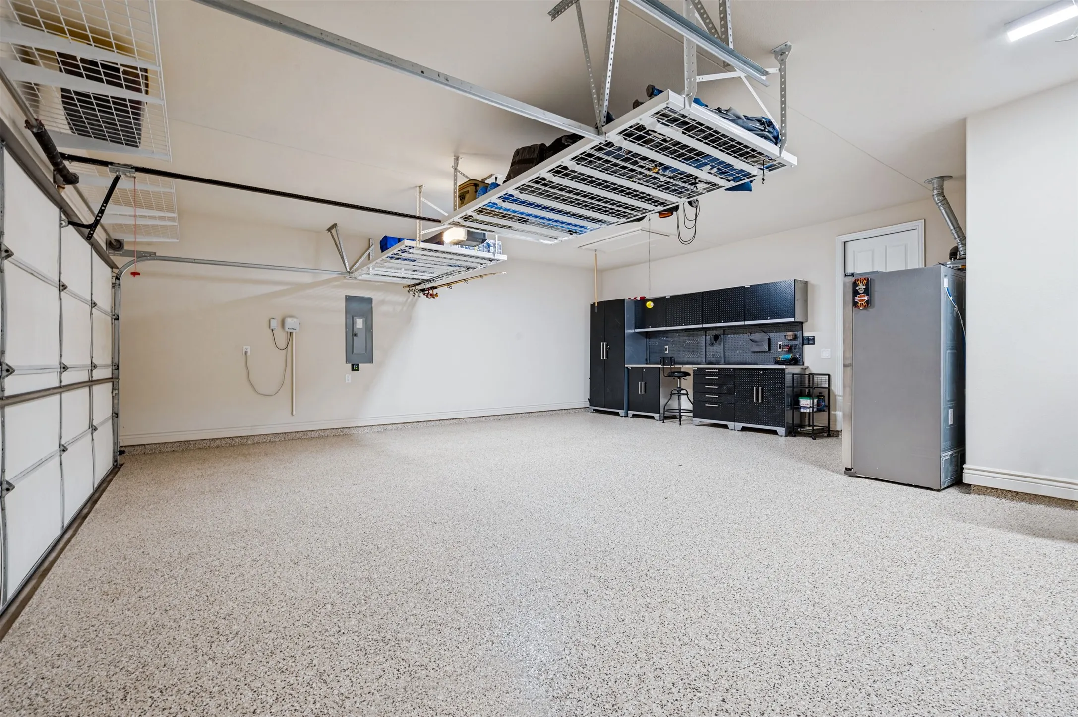 Garage with storage and epoxy coated floor, workbench and lots of light