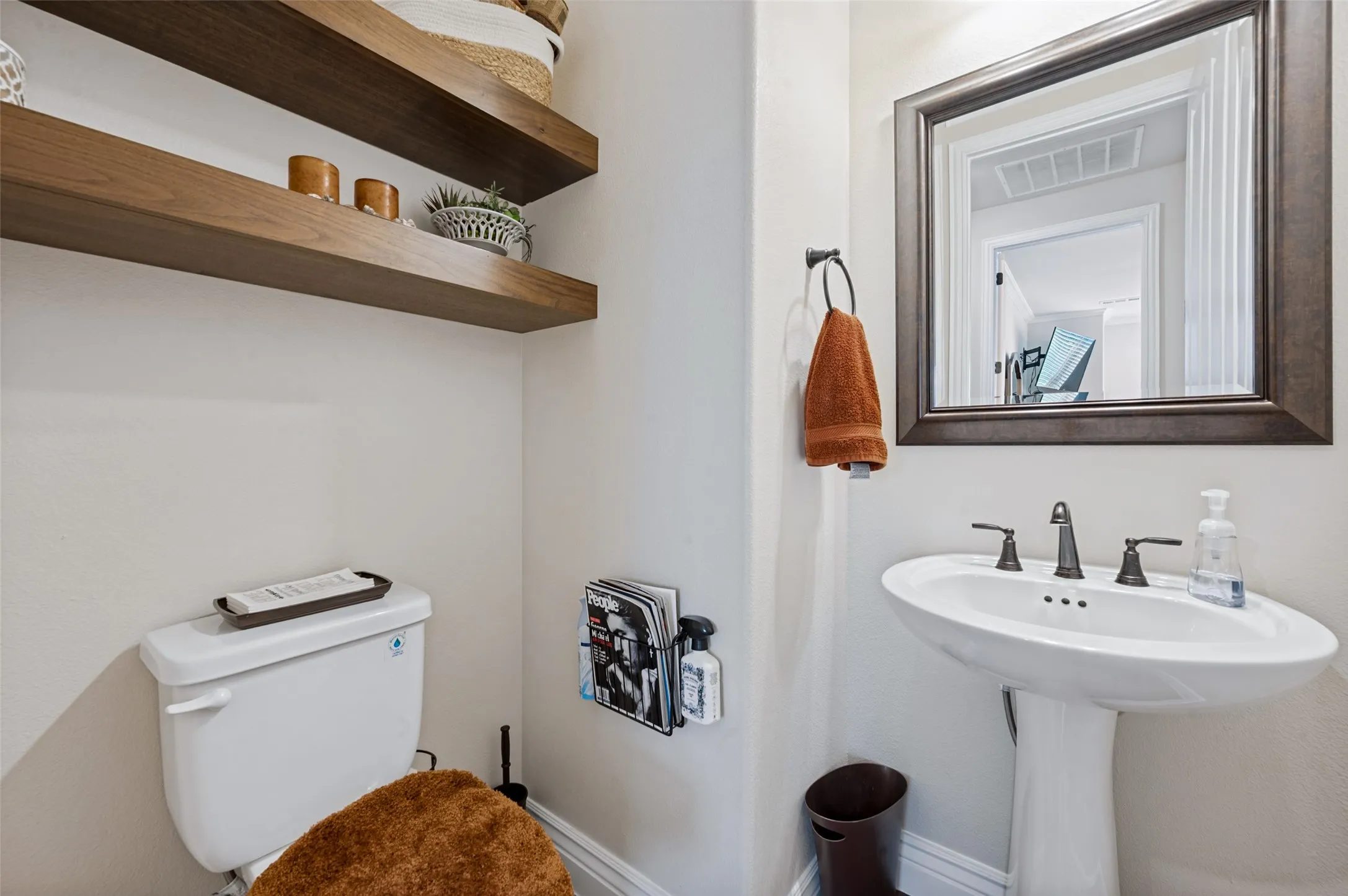 Half Bath with pedestal sink and open shelving