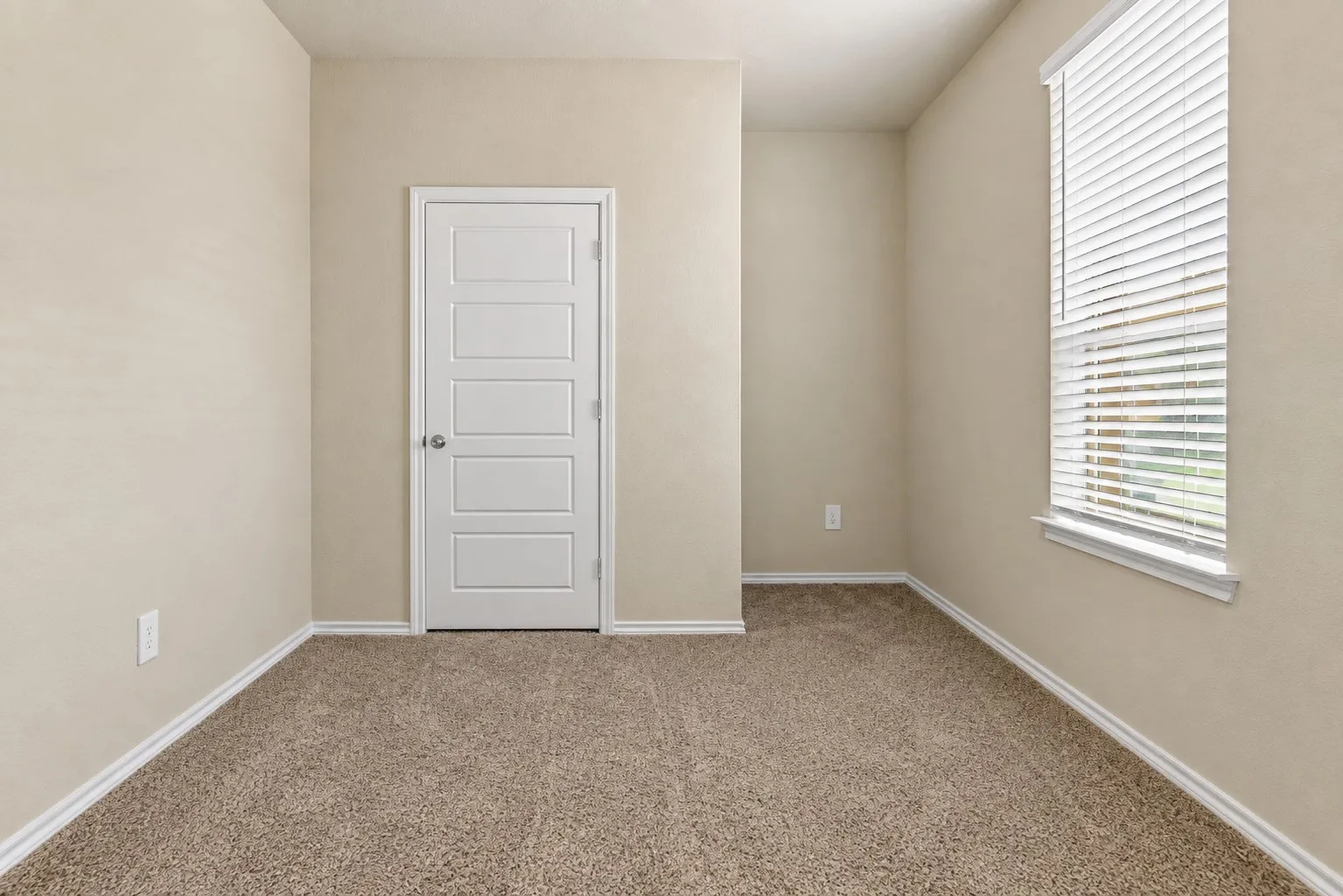 Neutral-toned wall paint, white trim, and beige carpet