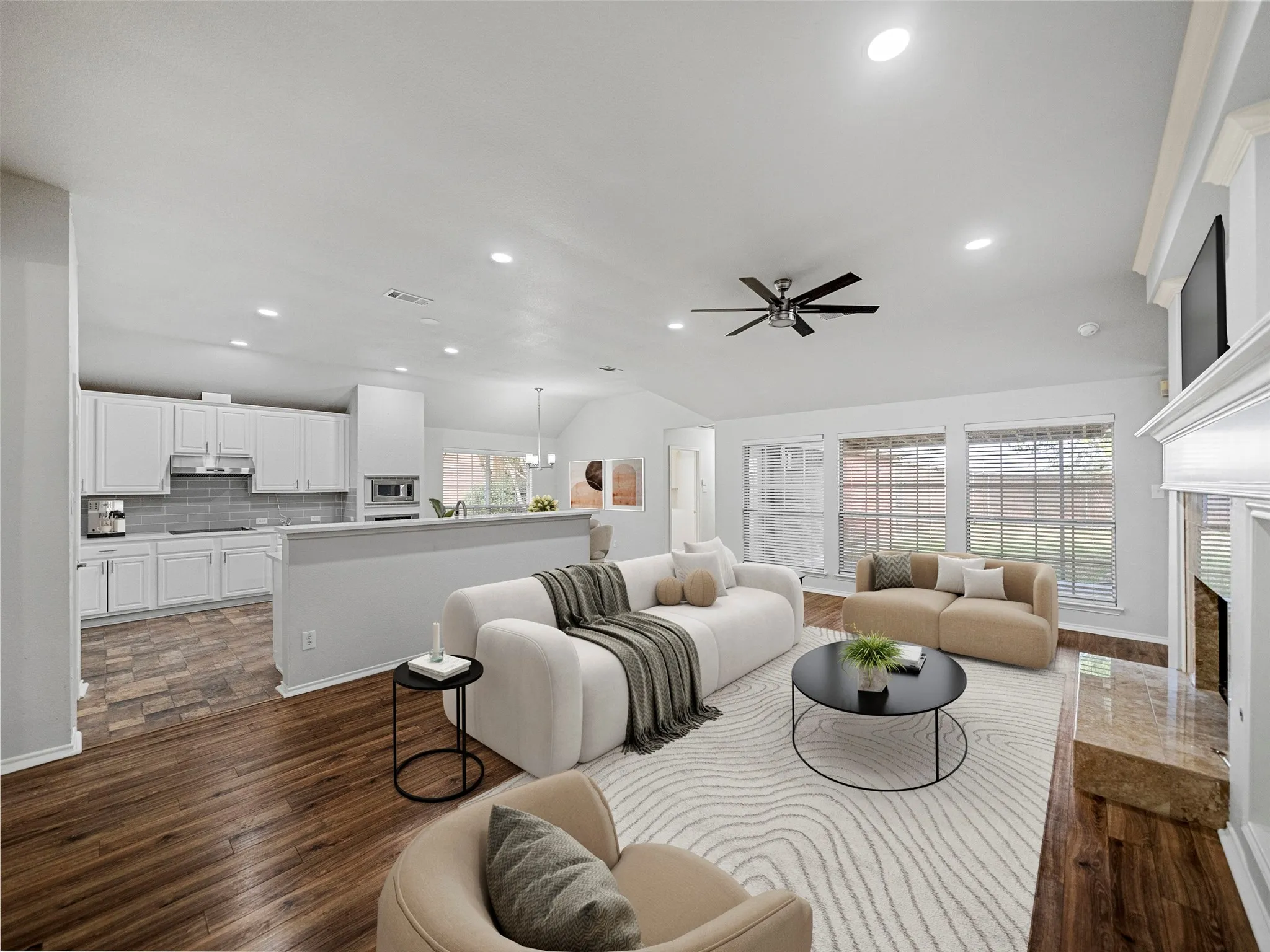 Open concept living area with vaulted ceiling, recessed lighting, and wood-finish flooring