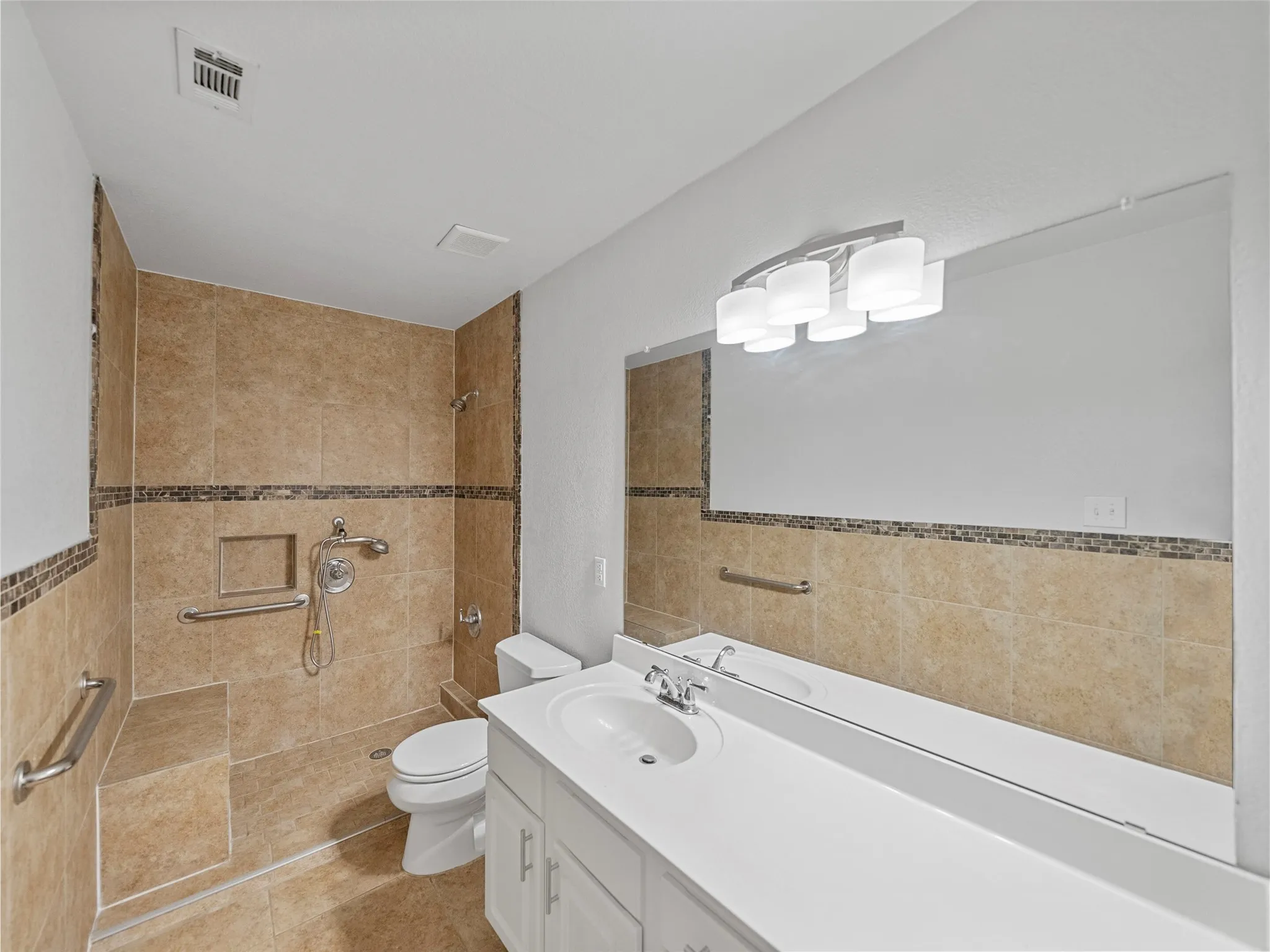 Tiled shower enclosure with built-in bench, integrated niche, and grab bars