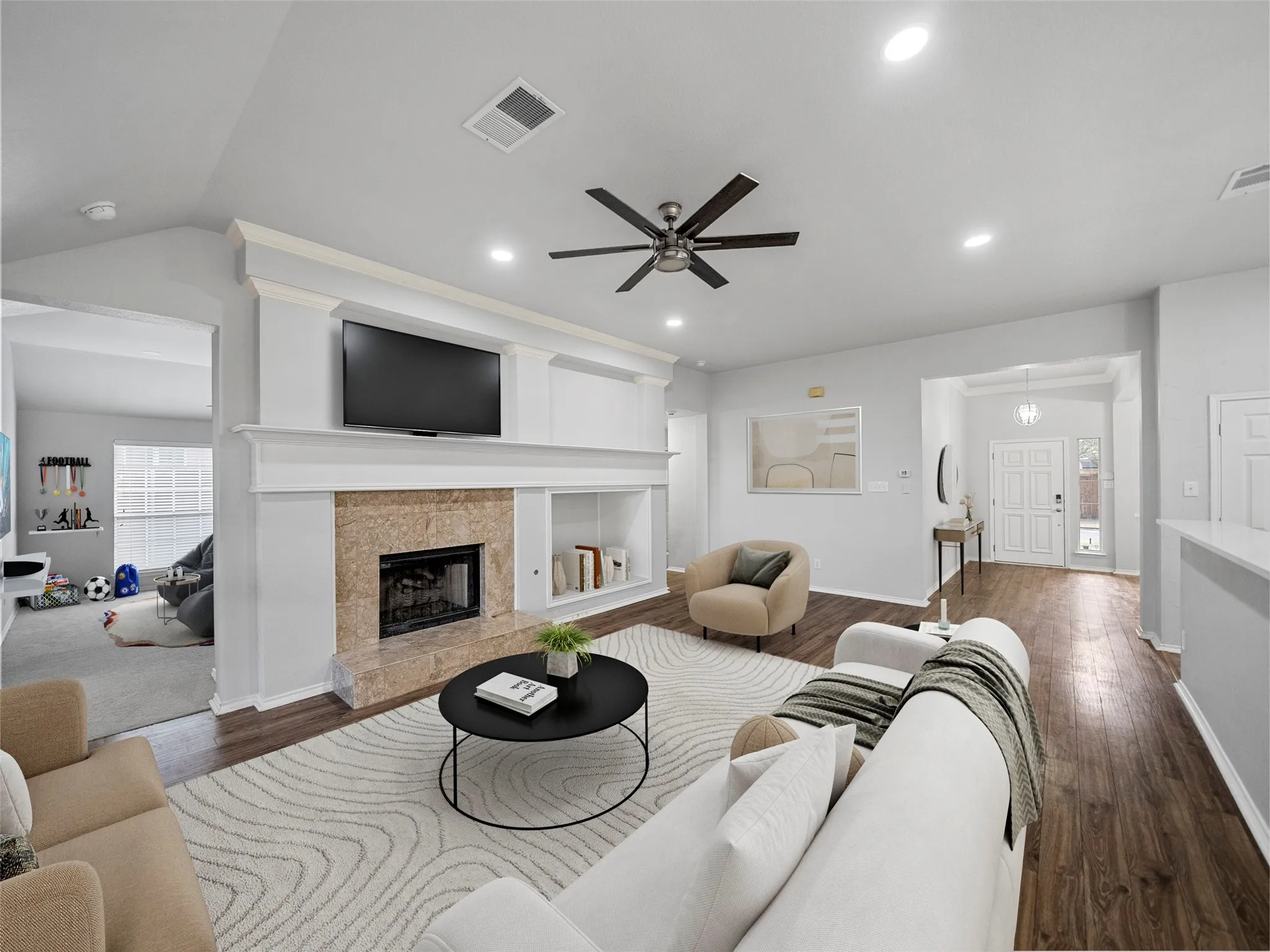 Fireplace with stone surround, built-in shelving, wood-finish flooring, recessed lighting, and a ceiling fan