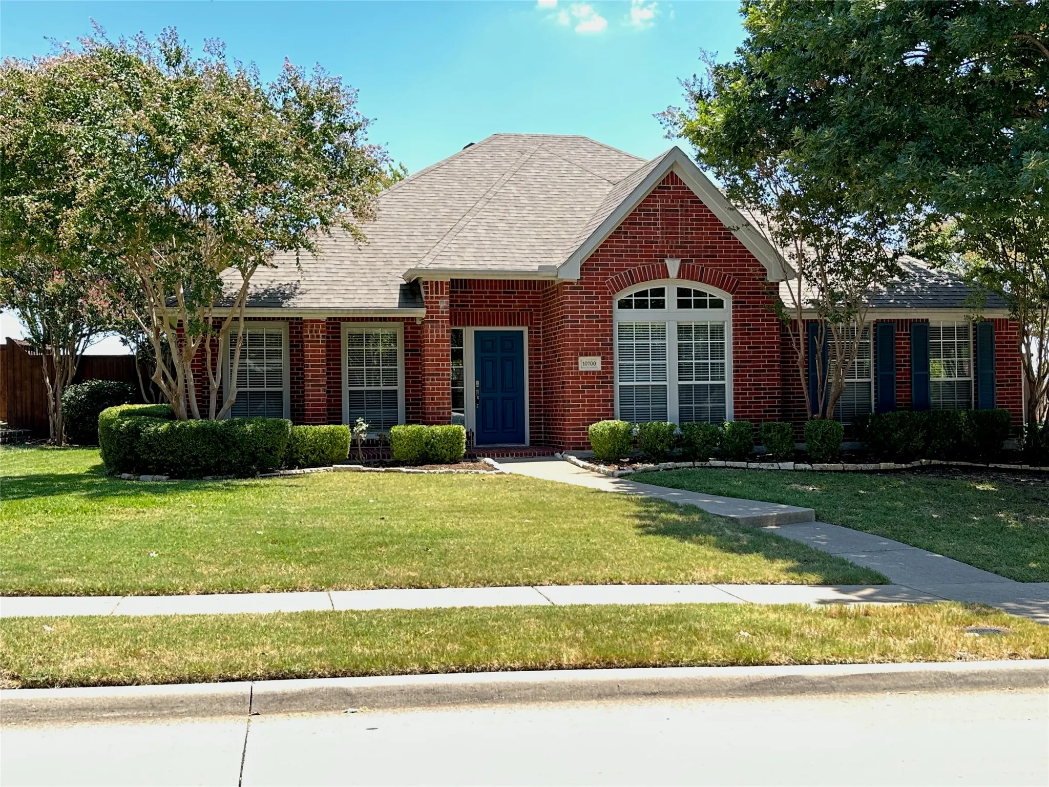 Red brick exterior with a gabled roofline and an arched window