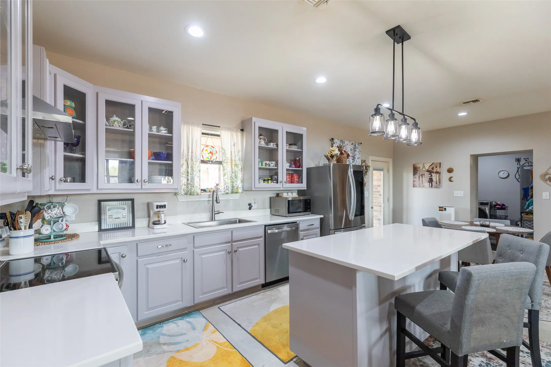 Kitchen featuring a center island with countertop seating, recessed lighting, and a contemporary linear pendant light fixture