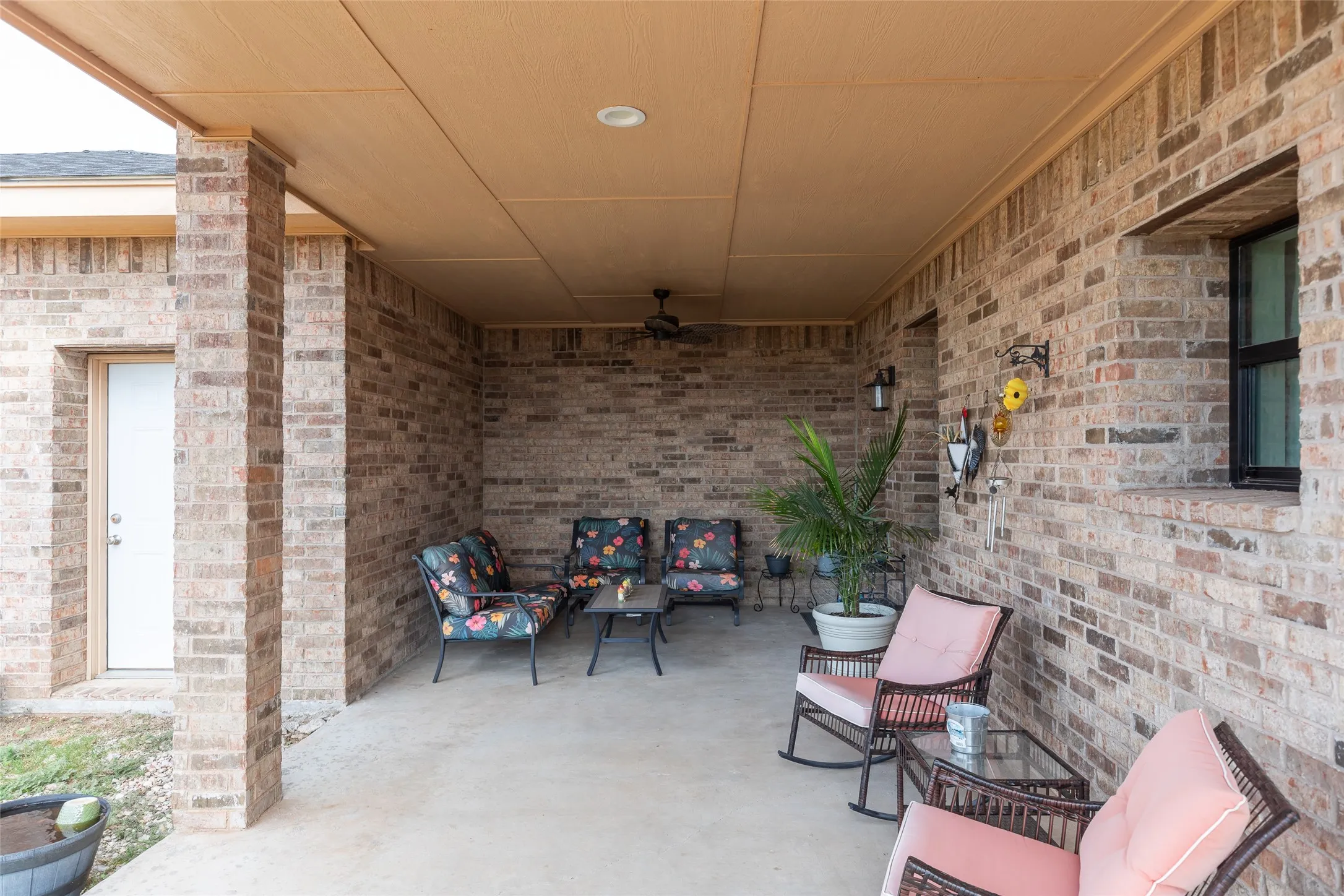 Covered patio featuring brick masonry, recessed lighting, and a ceiling fan