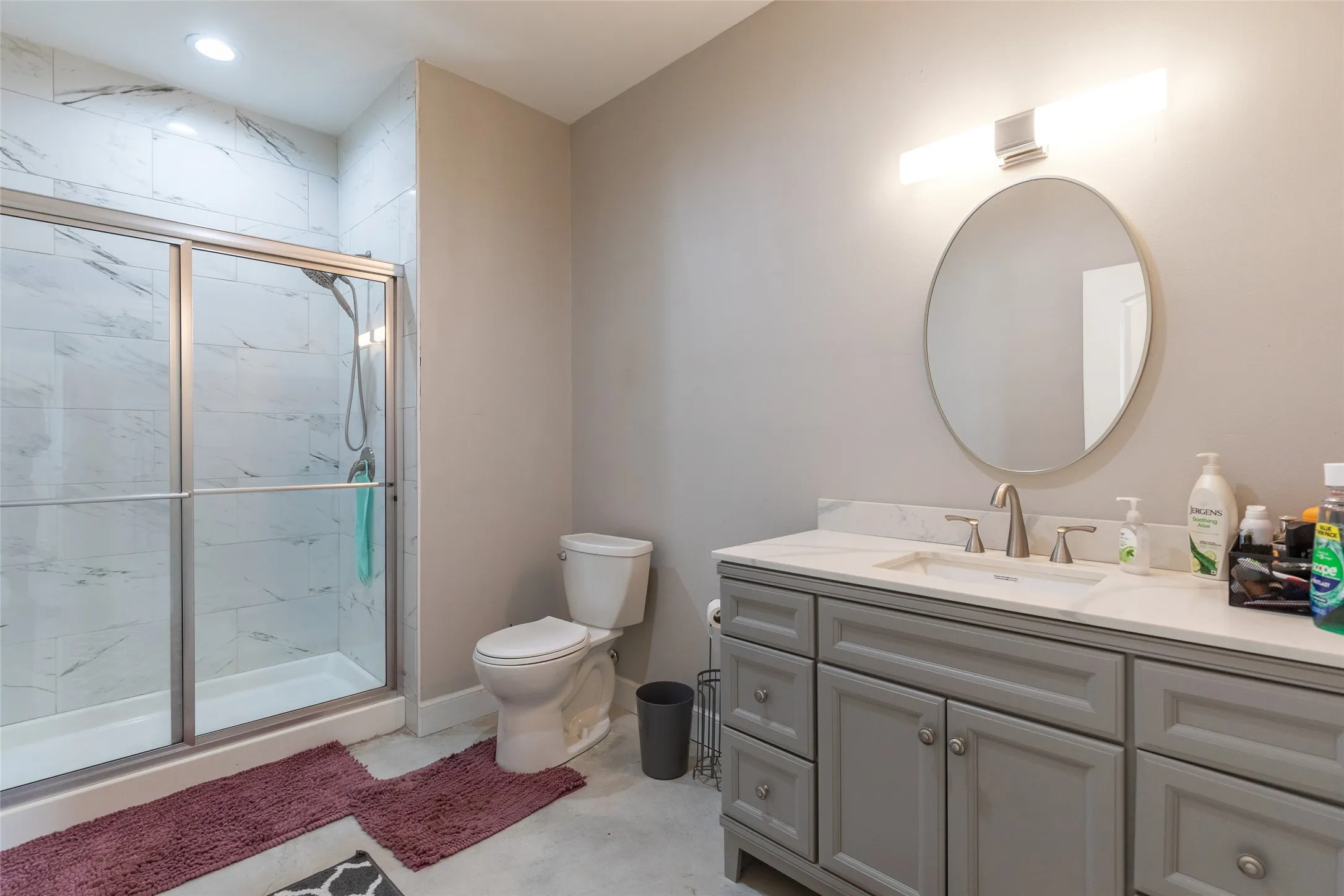 Walk-in shower with tiled surround and glass enclosure