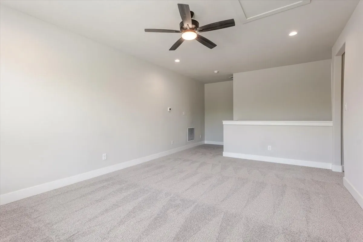 Carpeted room with recessed lighting, ceiling fan with integrated light, and white wall trim