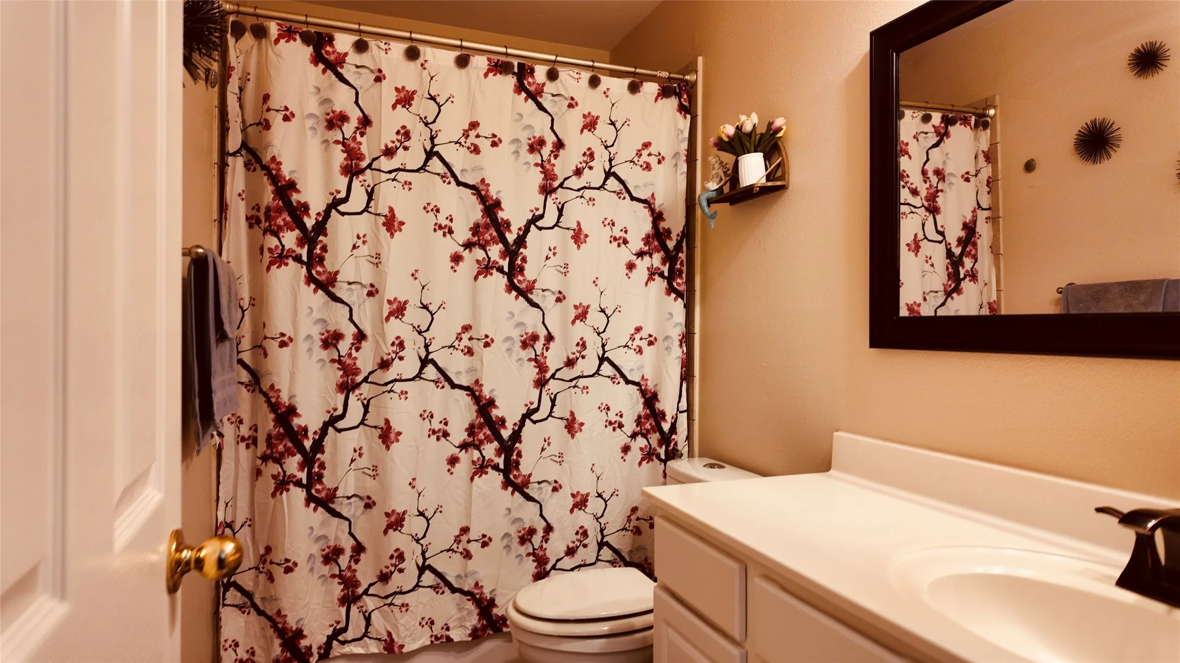 White vanity with an integrated sink and bronze-finish faucet