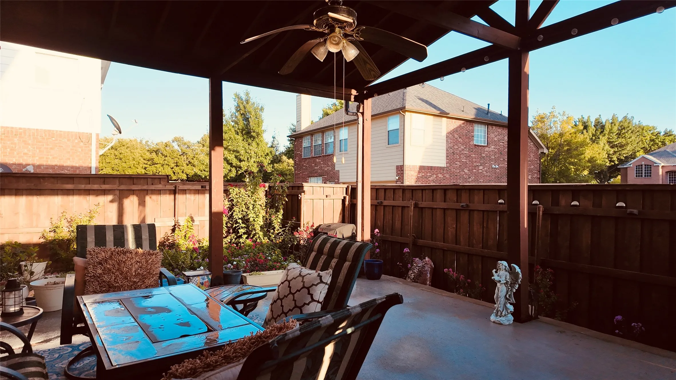 Covered patio featuring a ceiling fan, concrete flooring, and a privacy fence