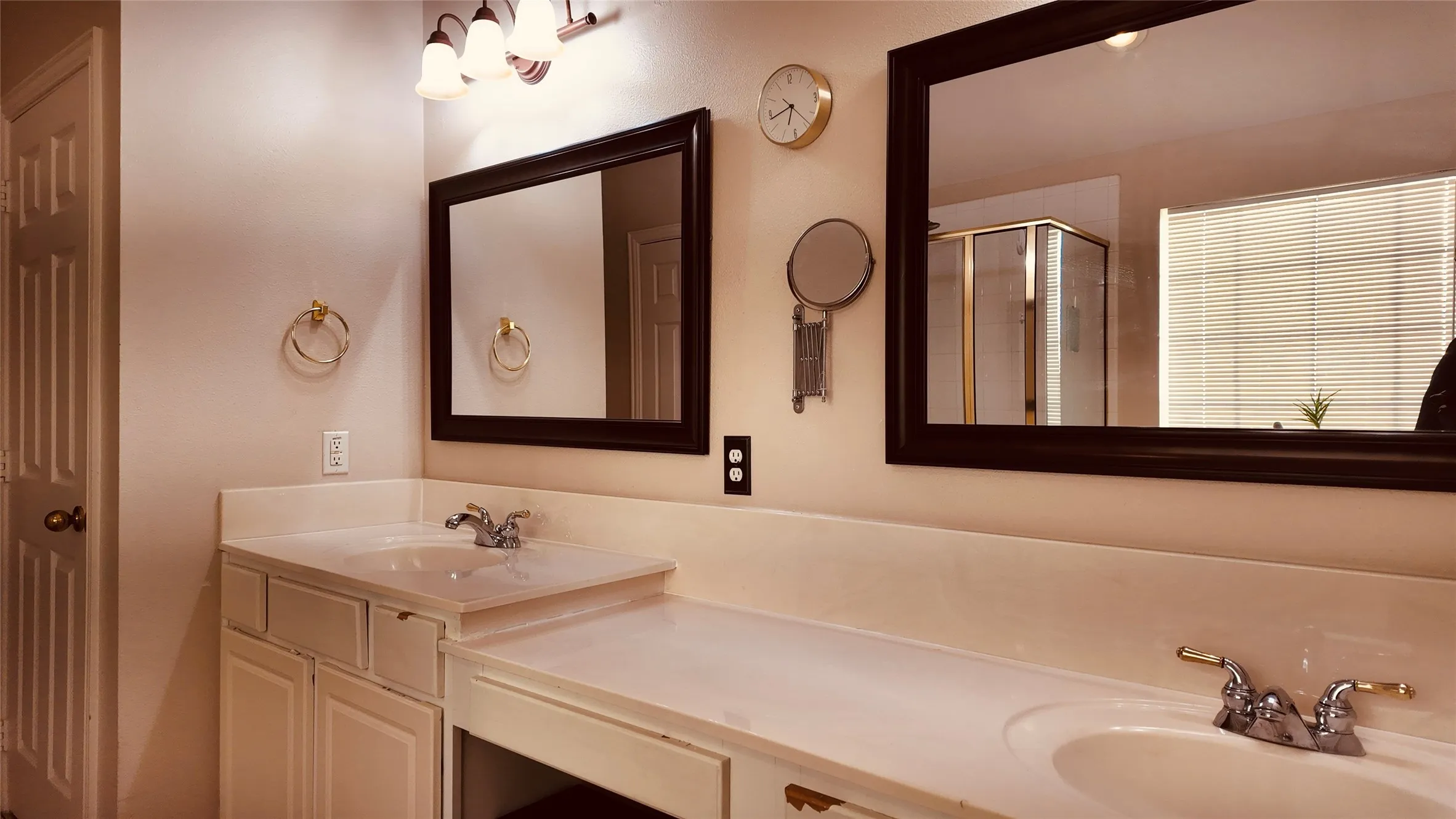 Dual vanity with integrated sinks, framed mirrors, and a dedicated makeup counter