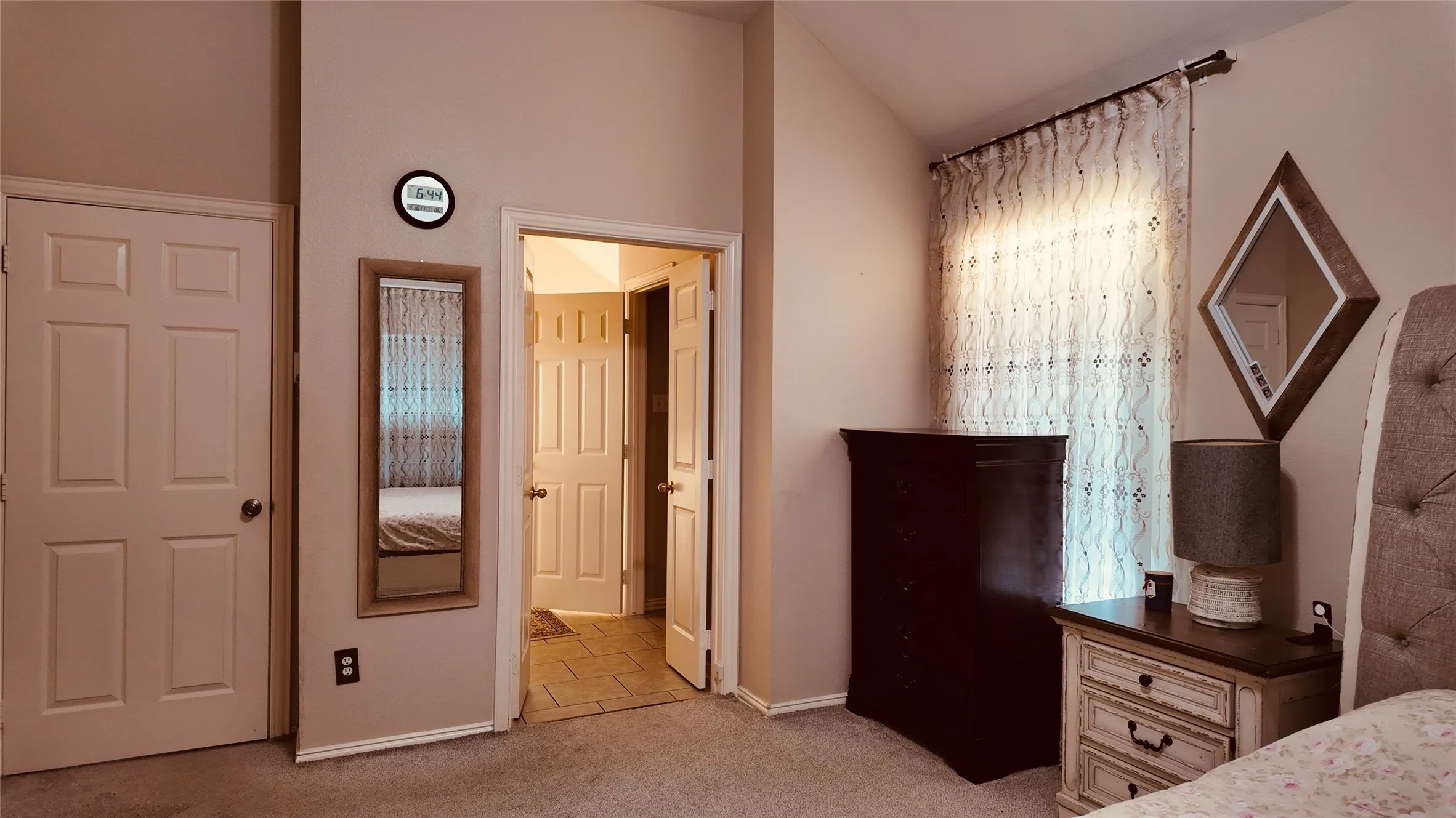 Carpeted flooring, vaulted ceiling, and panel doors