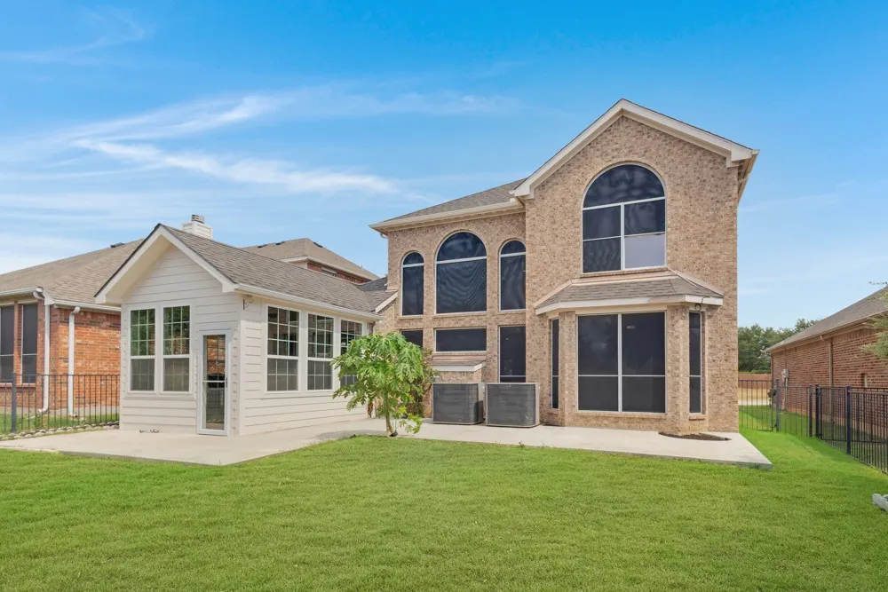 Expansive green lawn with a concrete patio