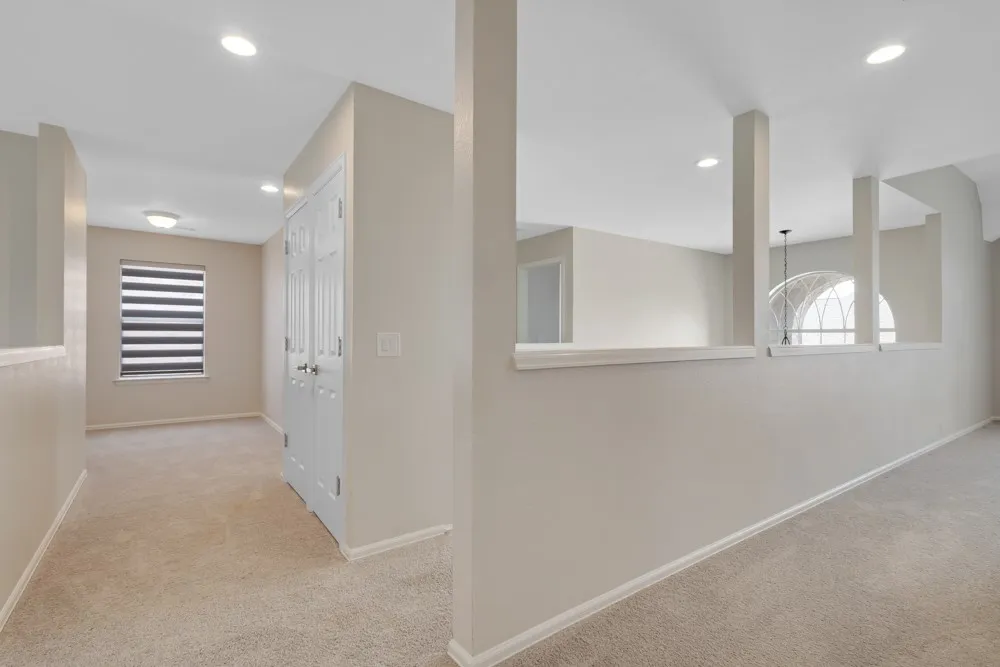 Carpeted flooring throughout, recessed lighting, and a window with horizontal blinds