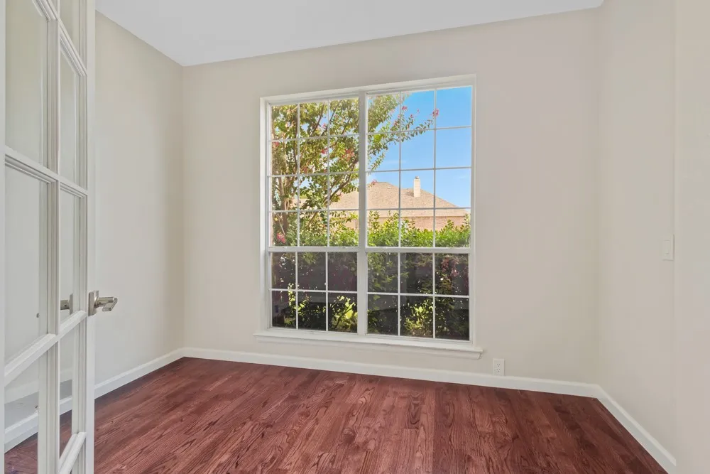 Wood-finish flooring with crisp white baseboards