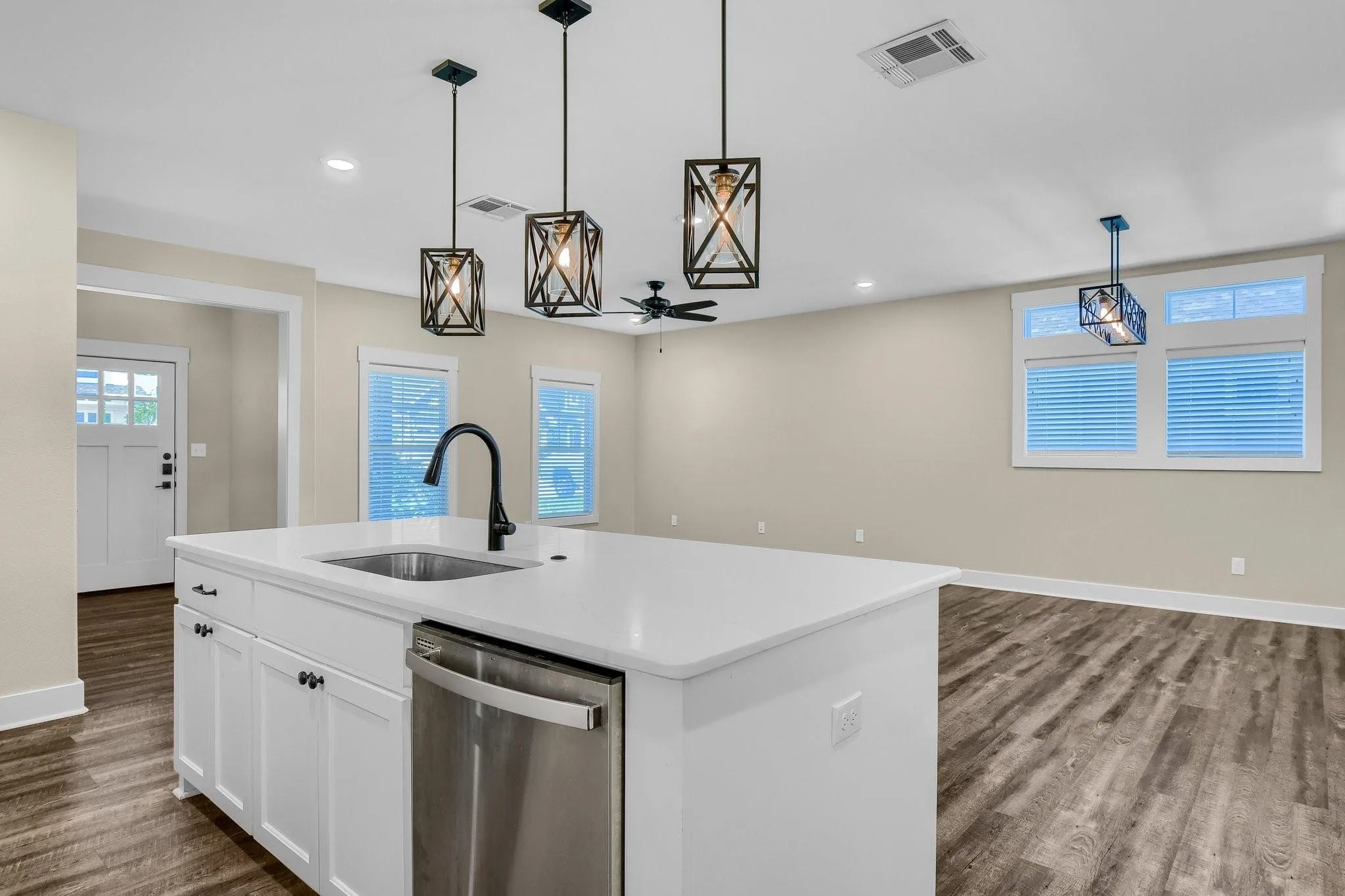 Kitchen island with an undermount sink, a gooseneck faucet, and integrated stainless steel dishwasher