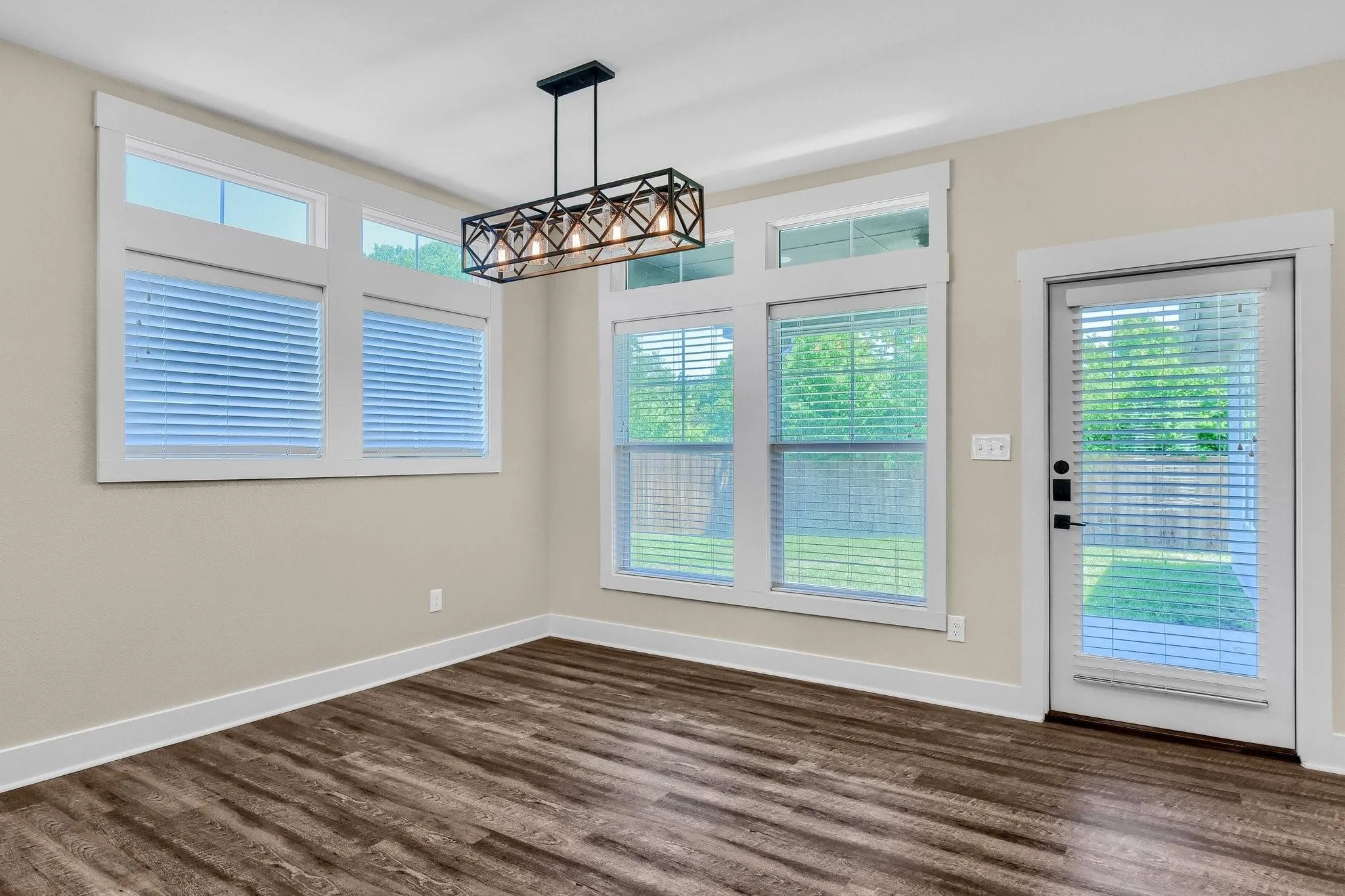 Wood-finish flooring with white baseboards