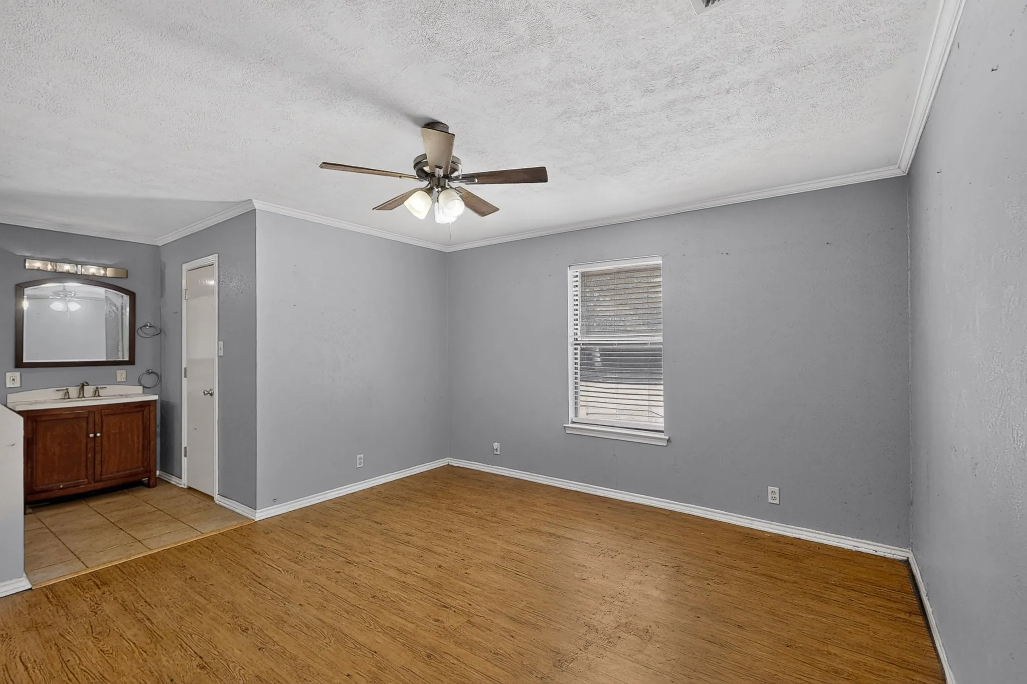 Wood-finish flooring and a ceiling fan in the main area