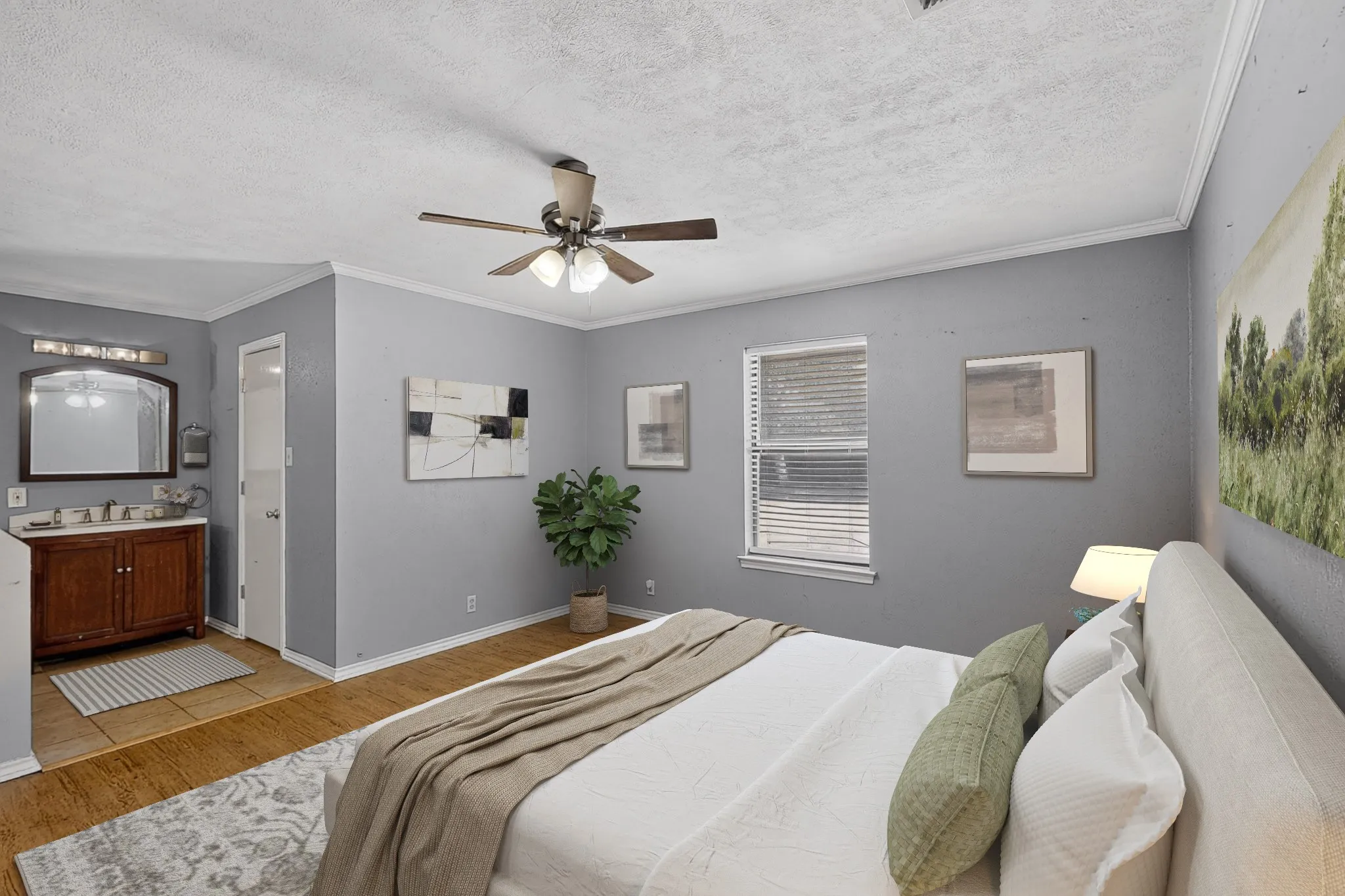 Ceiling fan with integrated lighting, wood-finish flooring, window with blinds, wood vanity with counter and mirror, and a white interior door