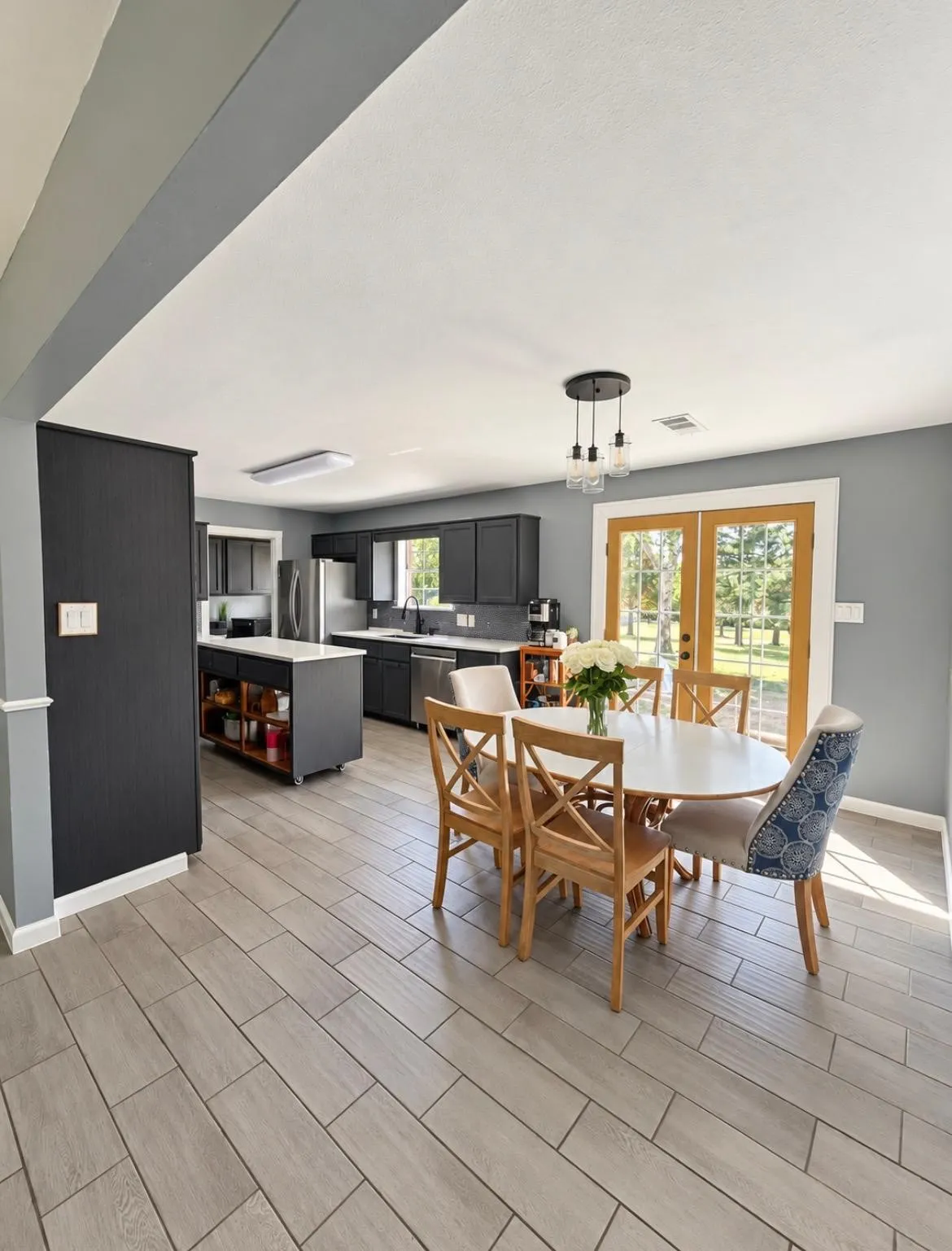 Kitchen with dark cabinetry and stainless steel appliances