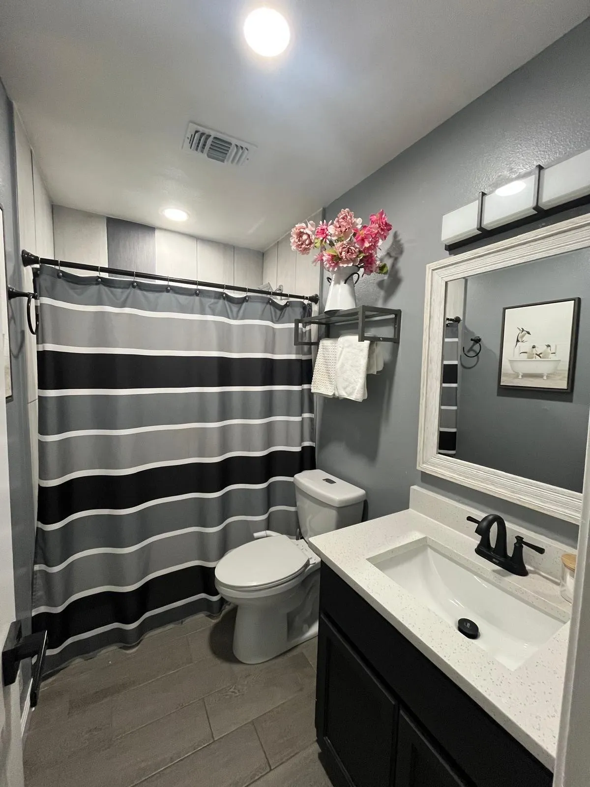 Vanity with integrated sink, black cabinet, and black faucet