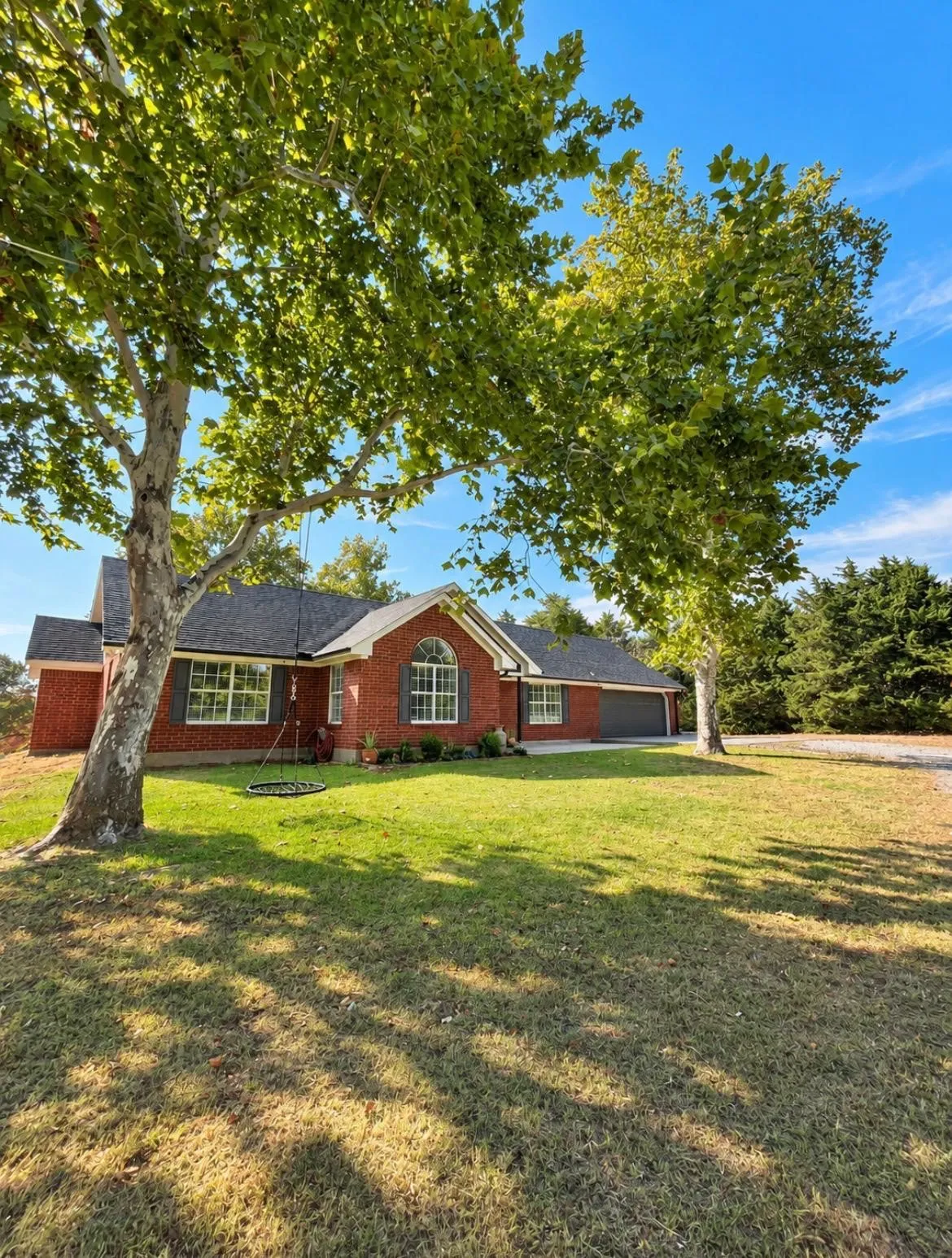 Red brick exterior with a dark shingled roof
