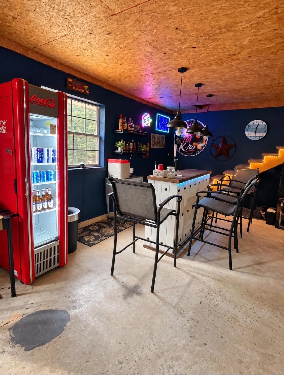 Built-in bar with pendant lighting, concrete flooring, and an exposed wood-finish ceiling