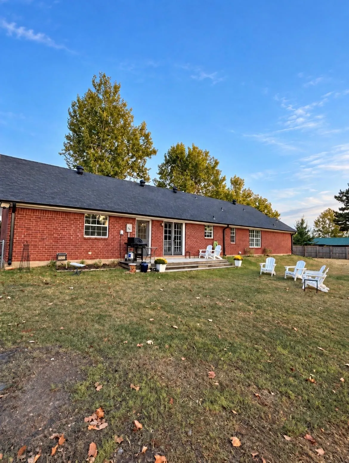 Red brick exterior with a dark shingle roof