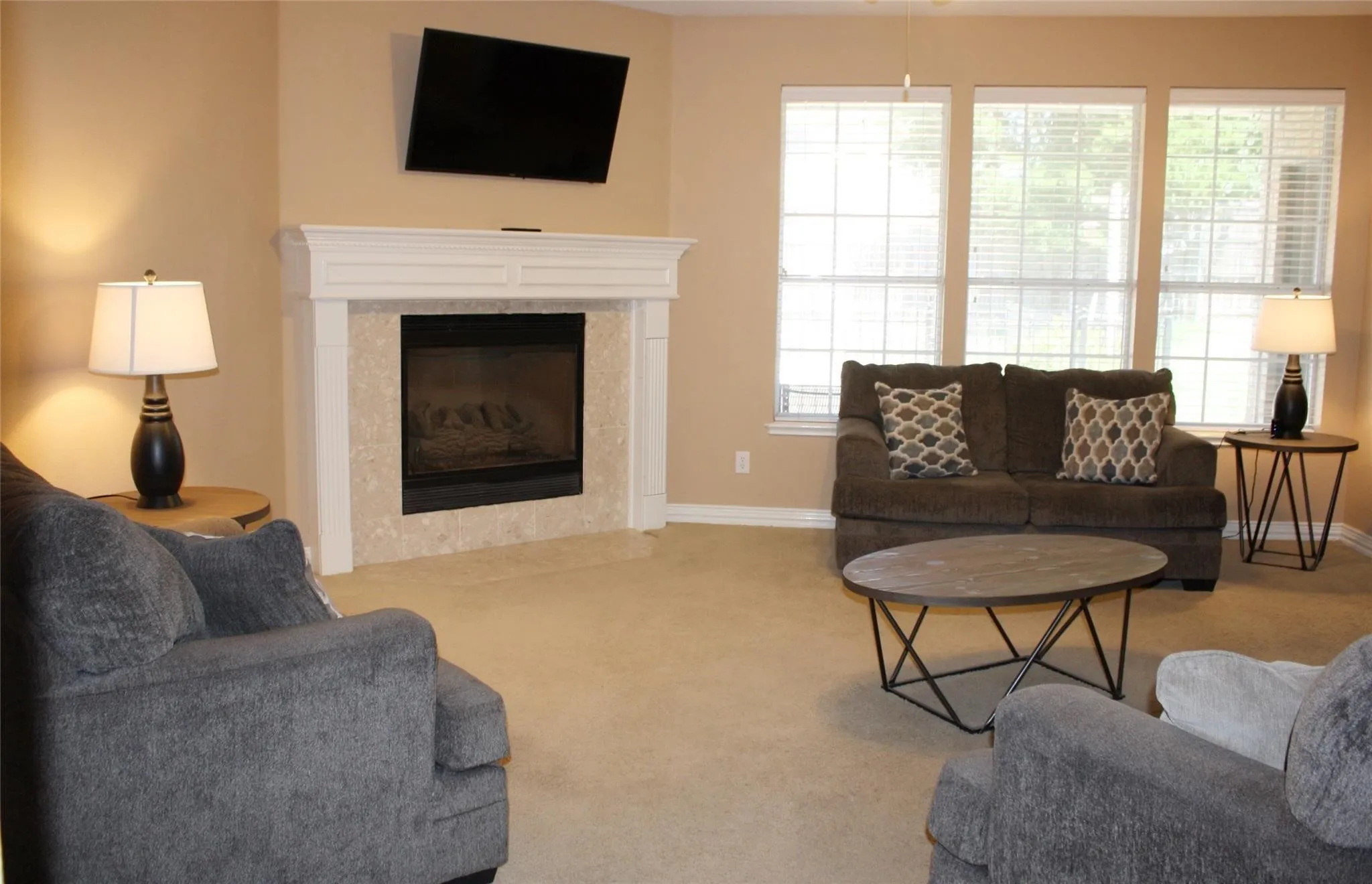 Built-in fireplace with a white mantel and light-toned stone surround