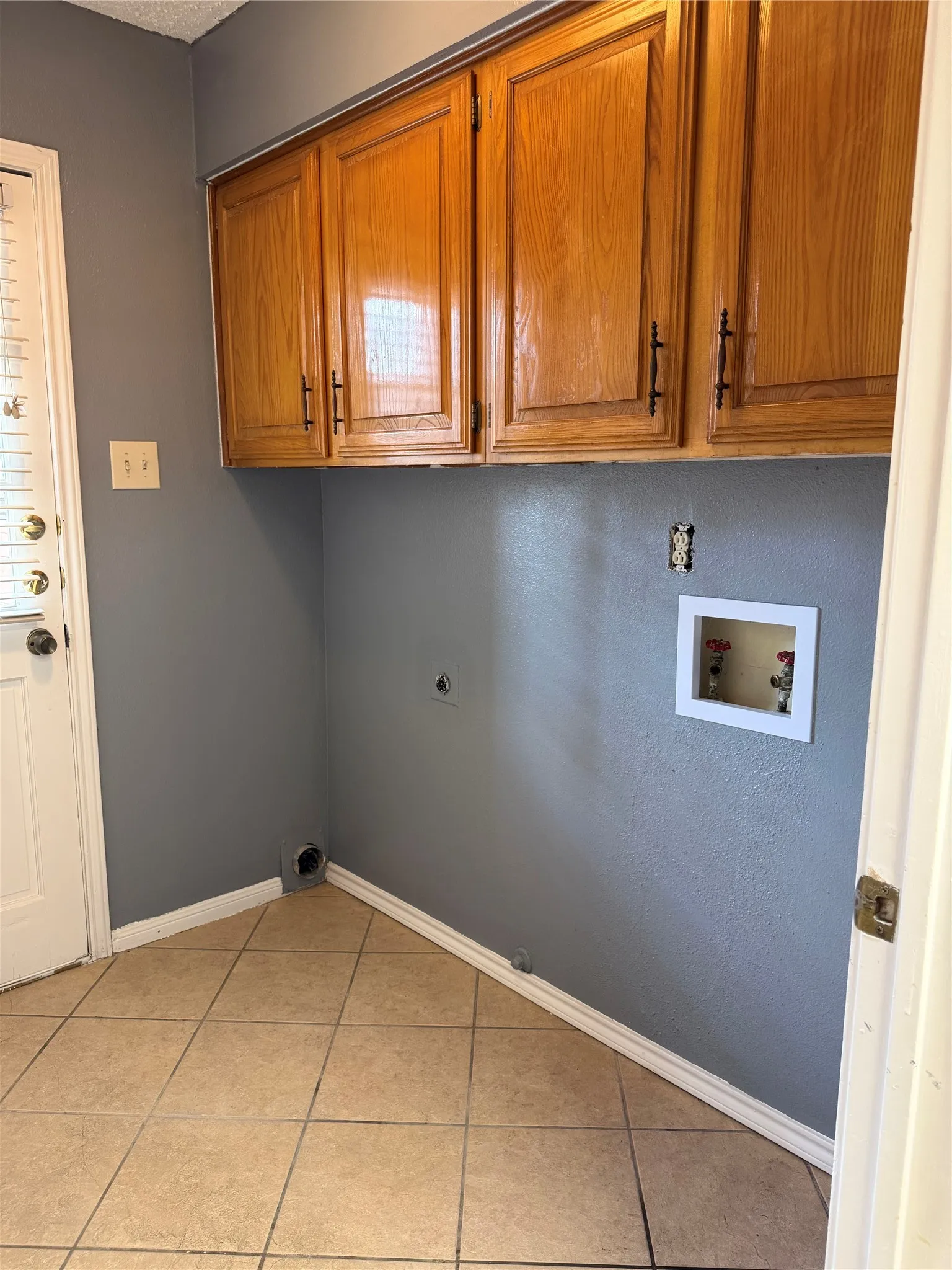 Warm wood-finish cabinetry provides storage