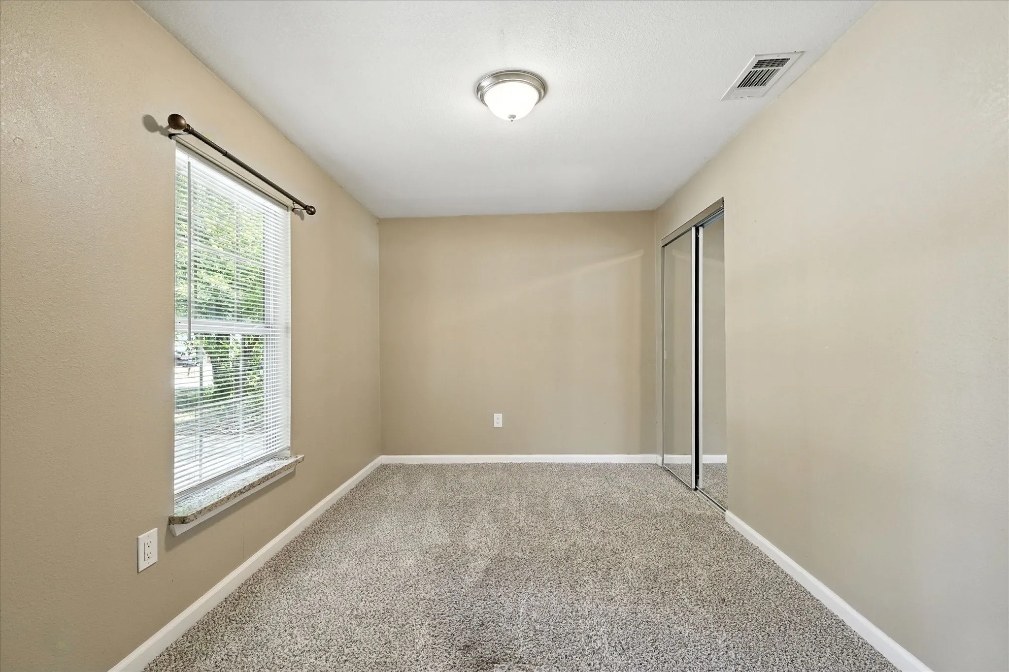 Secondary bedroom with view out the front of the  home