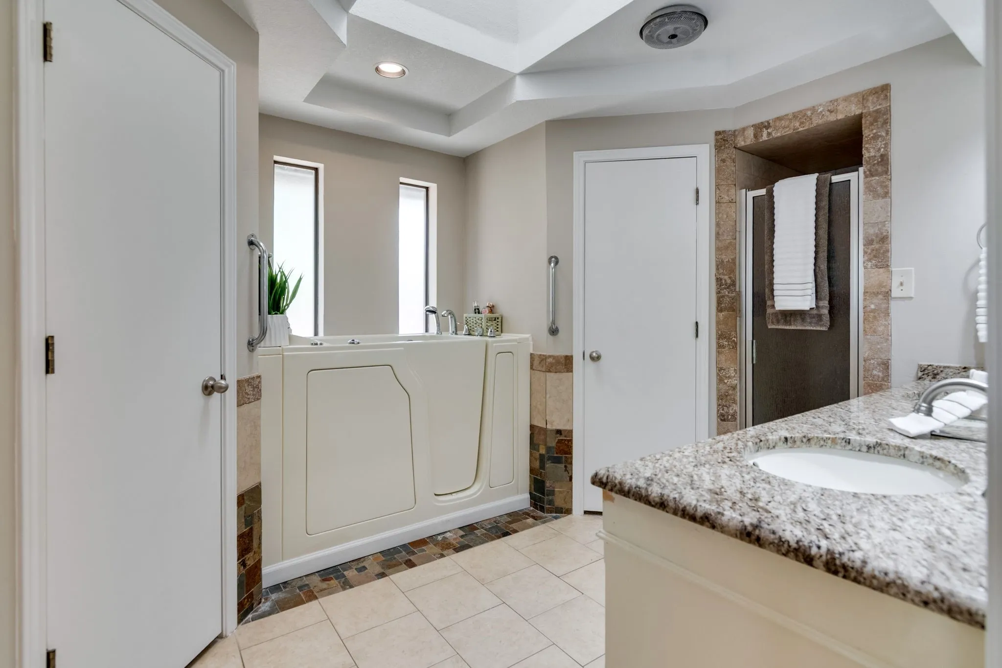 Primary bathroom has separate shower with walk in tub