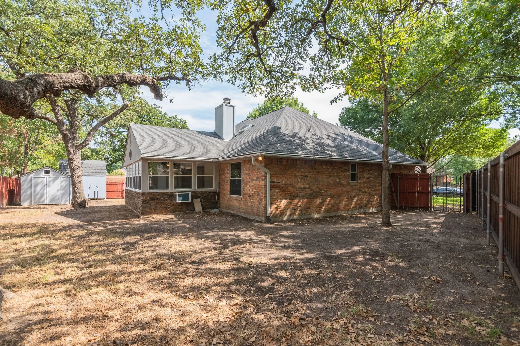Here is better view of the smaller (2nd) shed... on left side of this photo.  It's a large backyard with really pretty, big trees that provide a nice amount of shade!