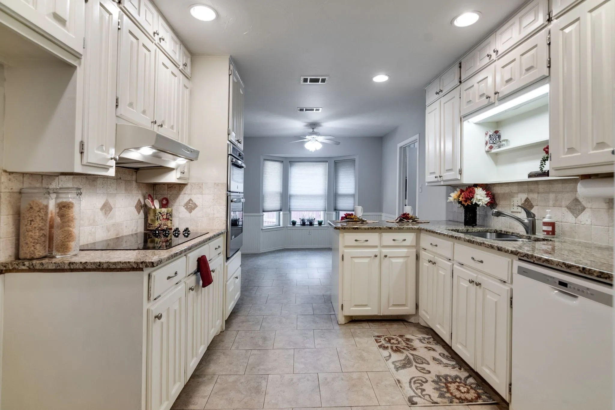 Tons of cabinets!  Kitchen looking towards breakfast nook with another bay window!