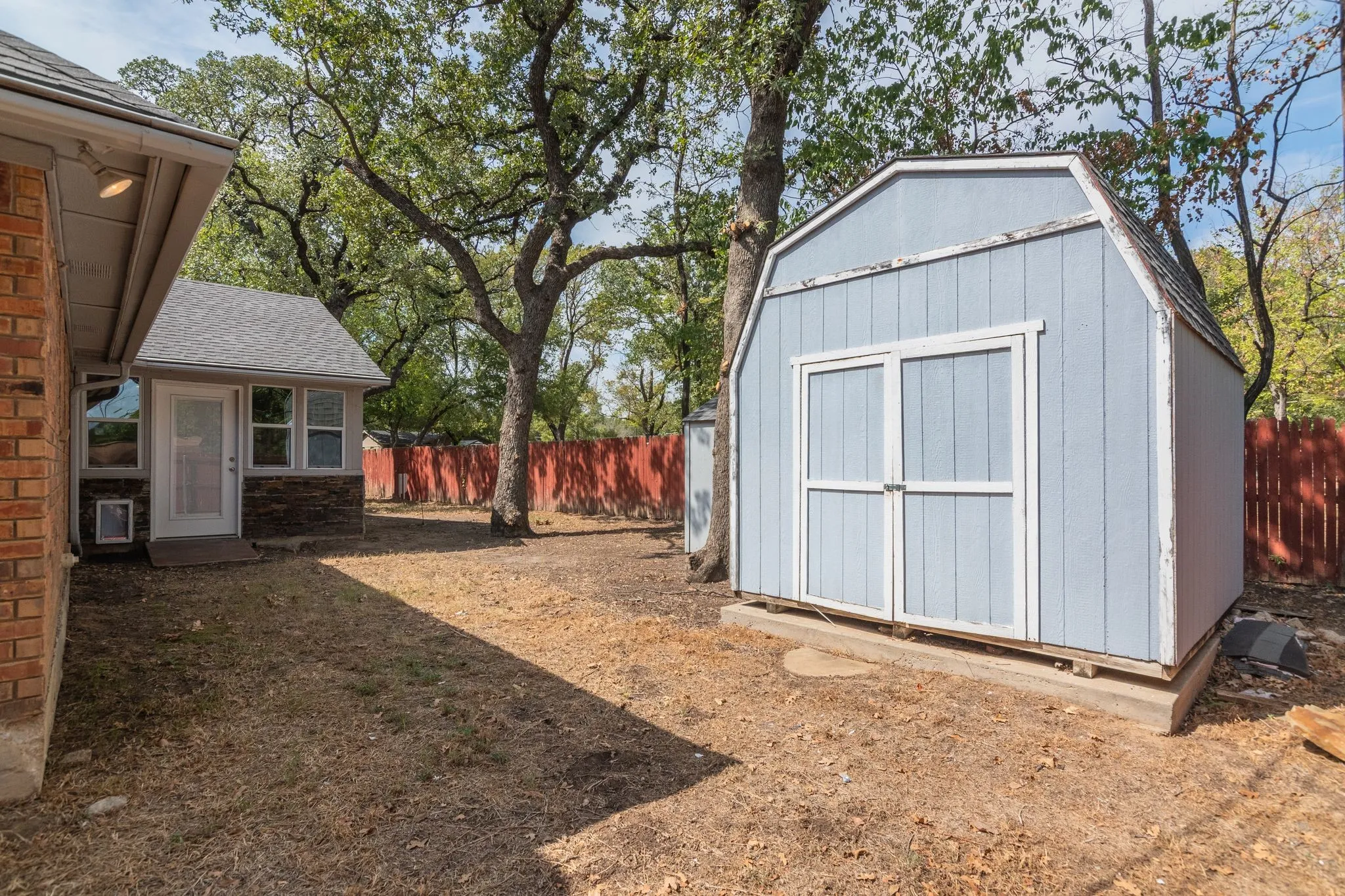 There are actually two wooden sheds!  You can see a small portion of the second smaller one just to the left of this larger one!