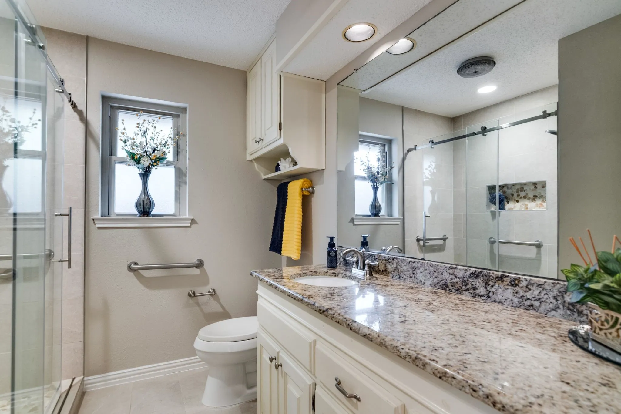 Hall bath has updated shower with glass doors