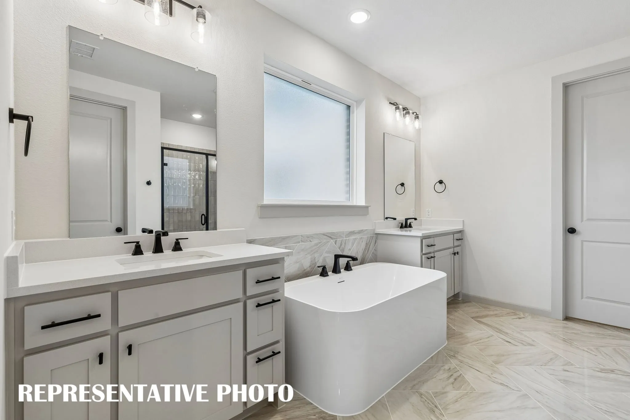 You'll enjoy ample room for two in this wonderfully designed owner's bath.  REPRESENTATIVE PHOTO