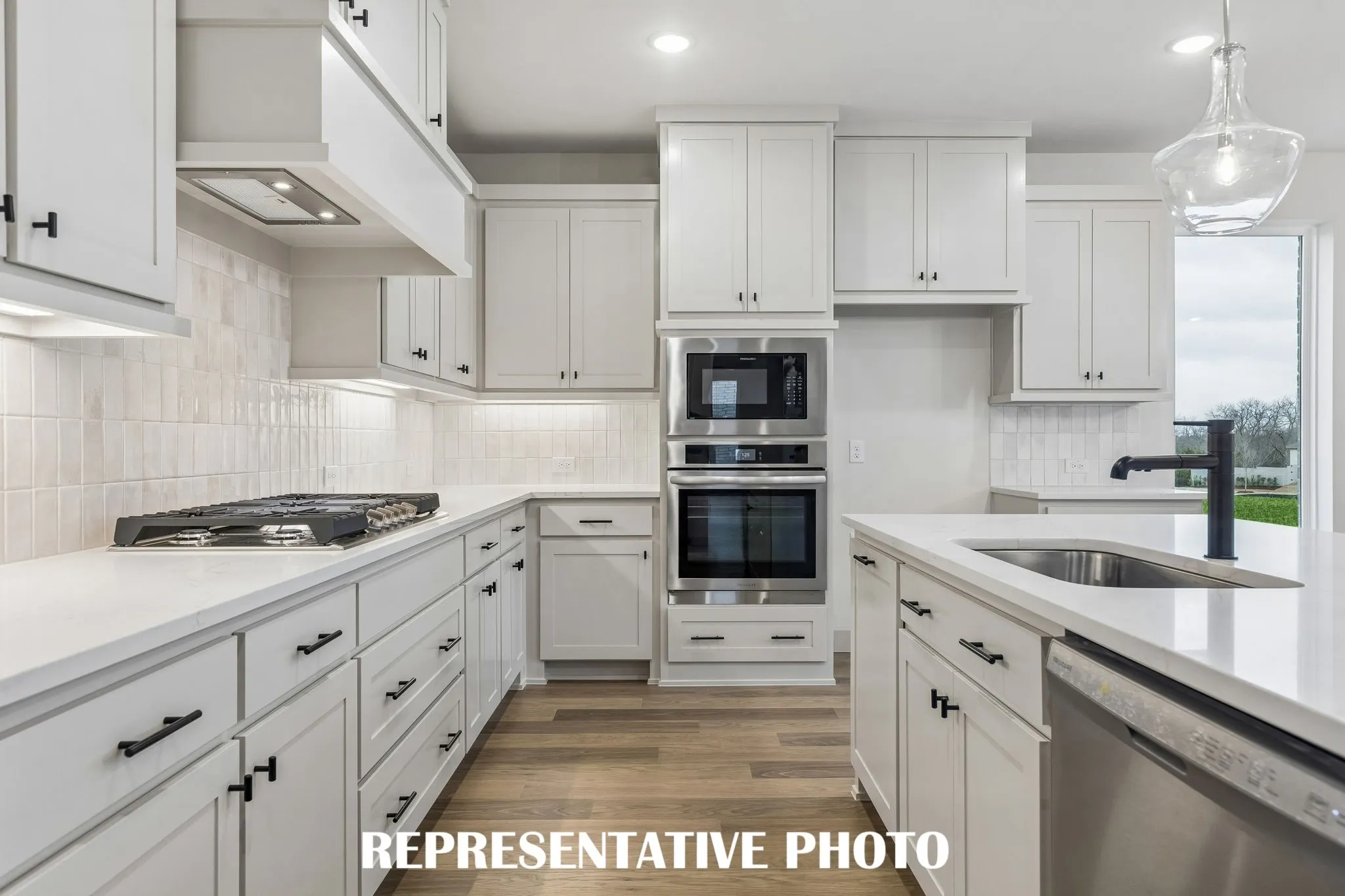 Beautiful cabinetry, gorgeous countertops and elegant backsplash effortlessly pair with contemporary stainless steel to create a classically styled dream kitchen!  REPRESENTATIVE PHOTO