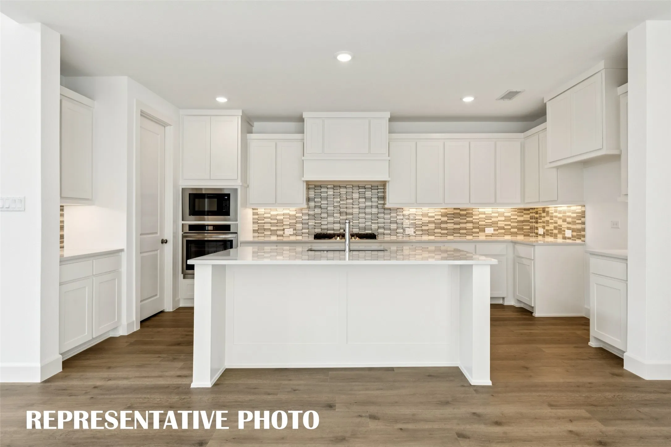 Welcome to your dream kitchen featuring gorgeous cabinetry, contemporary countertops, and stainless appliances.  REPRESENTATIVE PHOTO