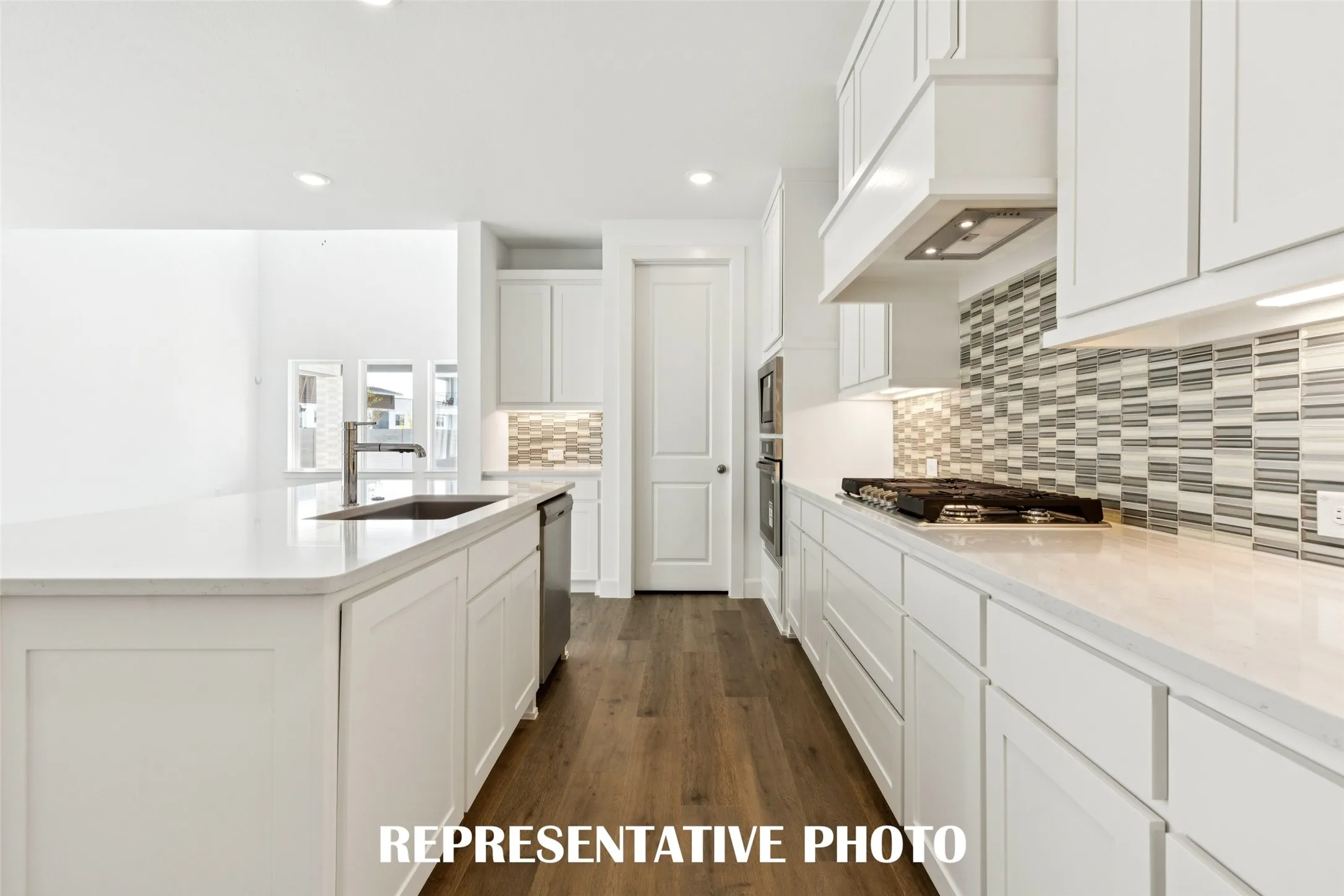 You'll find thoughtful design elements like pull out trash, pot & pan drawers and walk in pantry throughout this chef's dream kitchen!  REPRESENTATIVE PHOTO