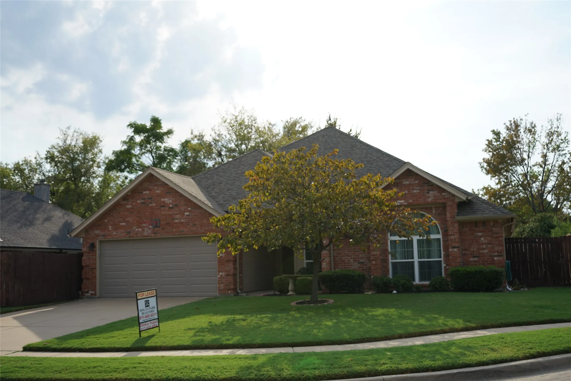 Red brick exterior with a grey shingle roof