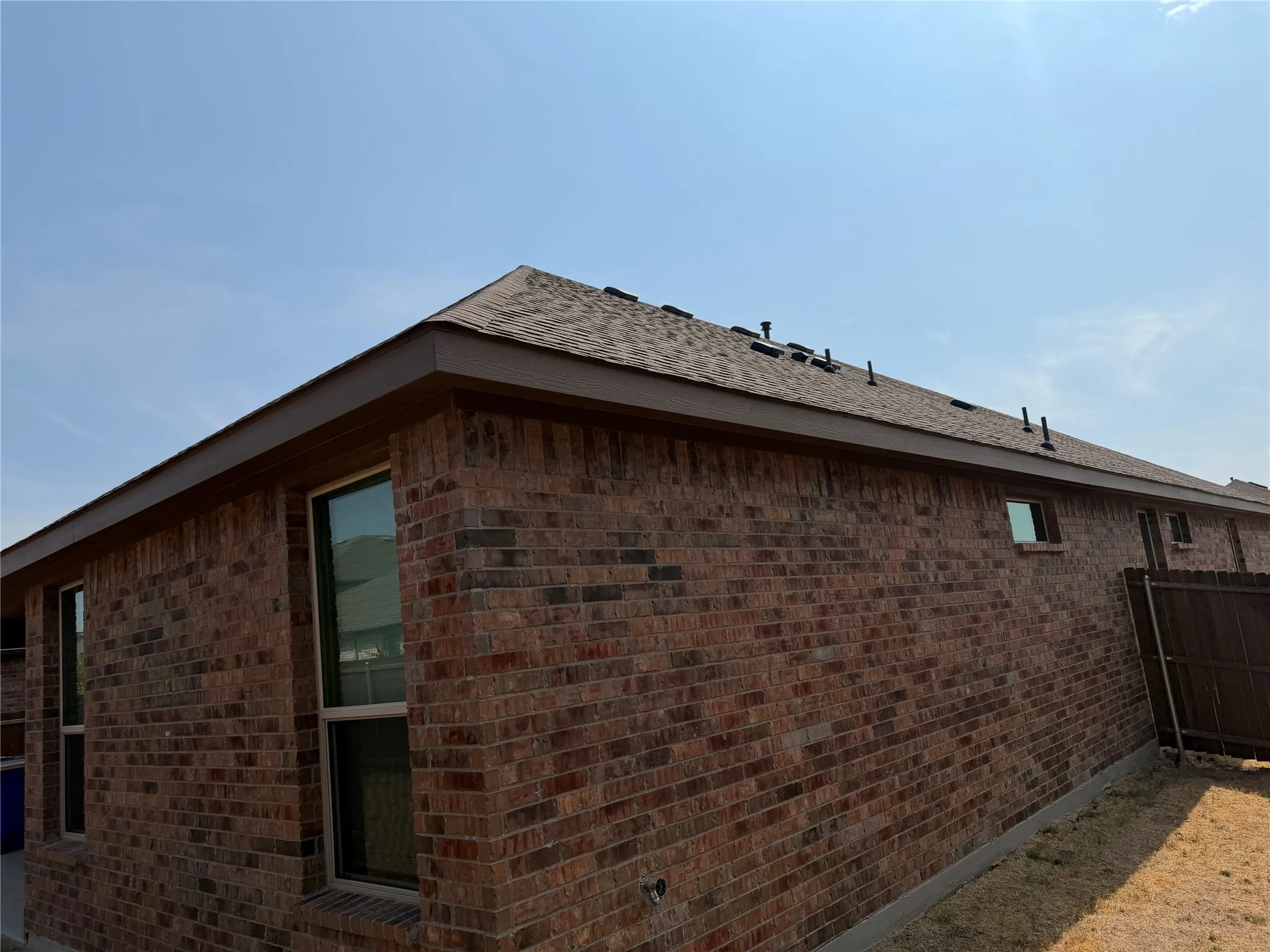 Red brick exterior with a shingle roof