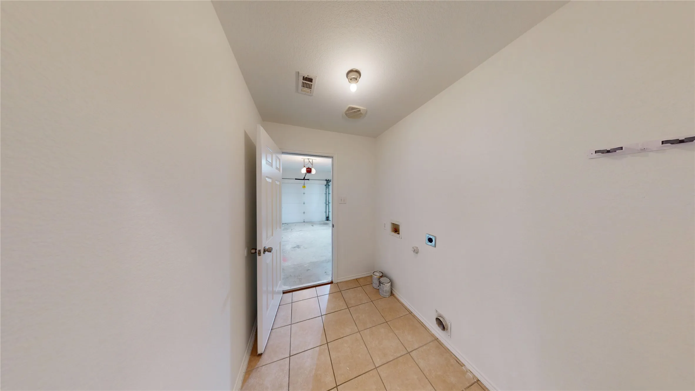Tile flooring throughout with a neutral wall finish