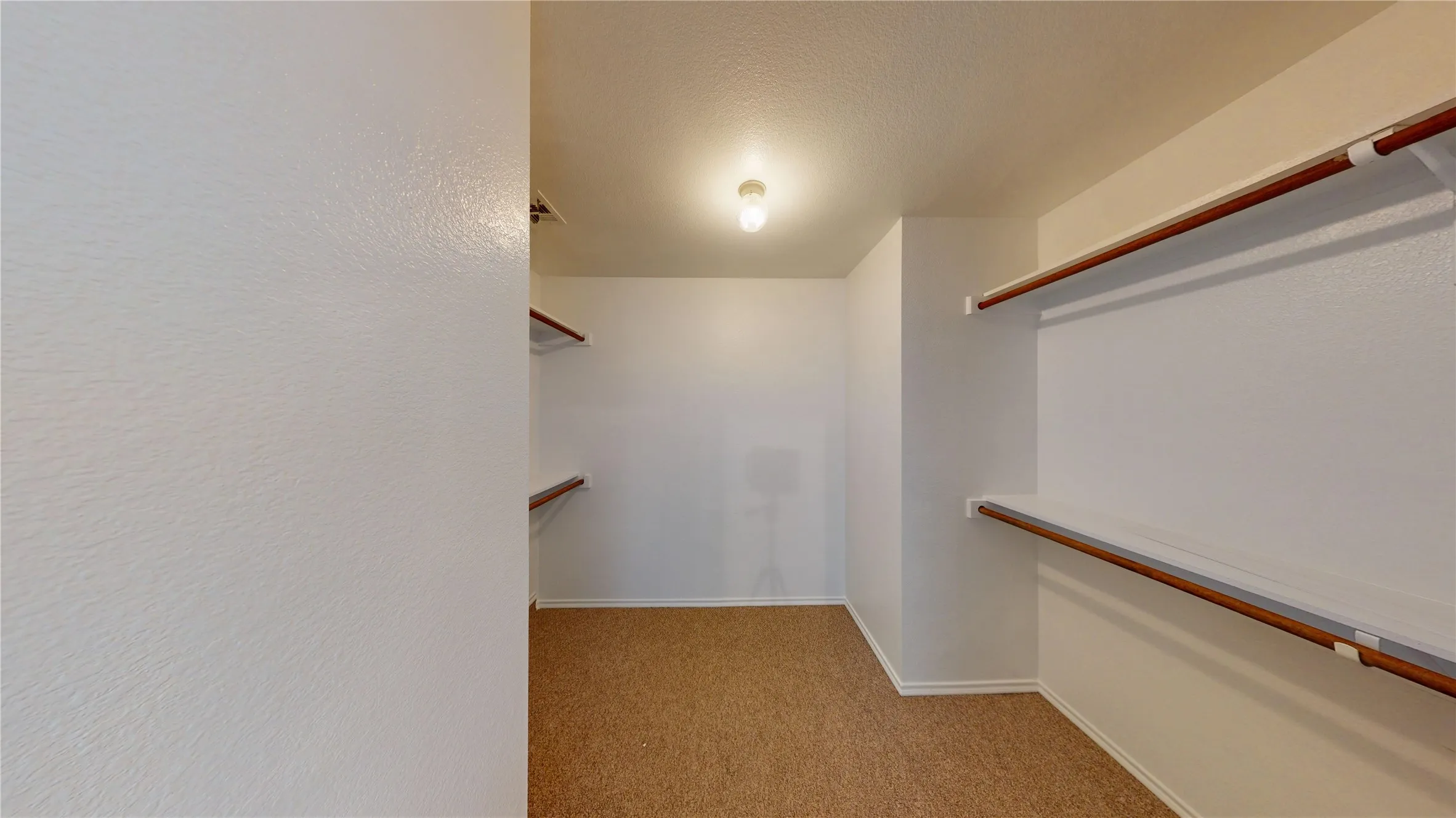 Spacious walk-in closet with integrated shelving and hanging rods