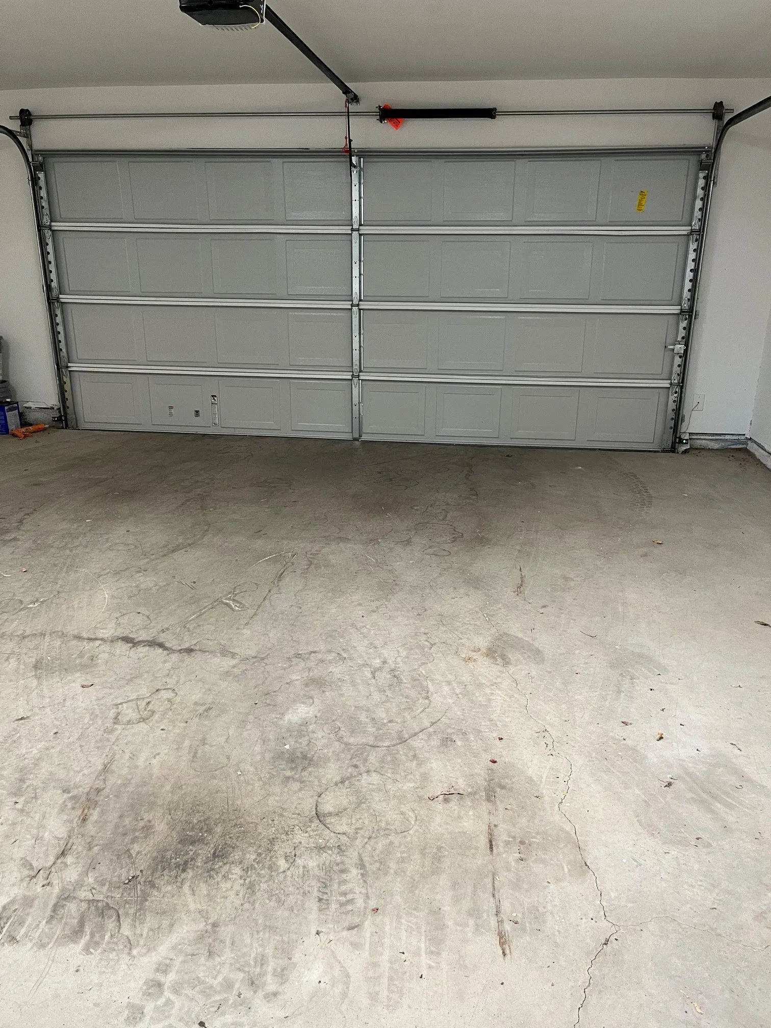 Sectional garage door with a concrete floor